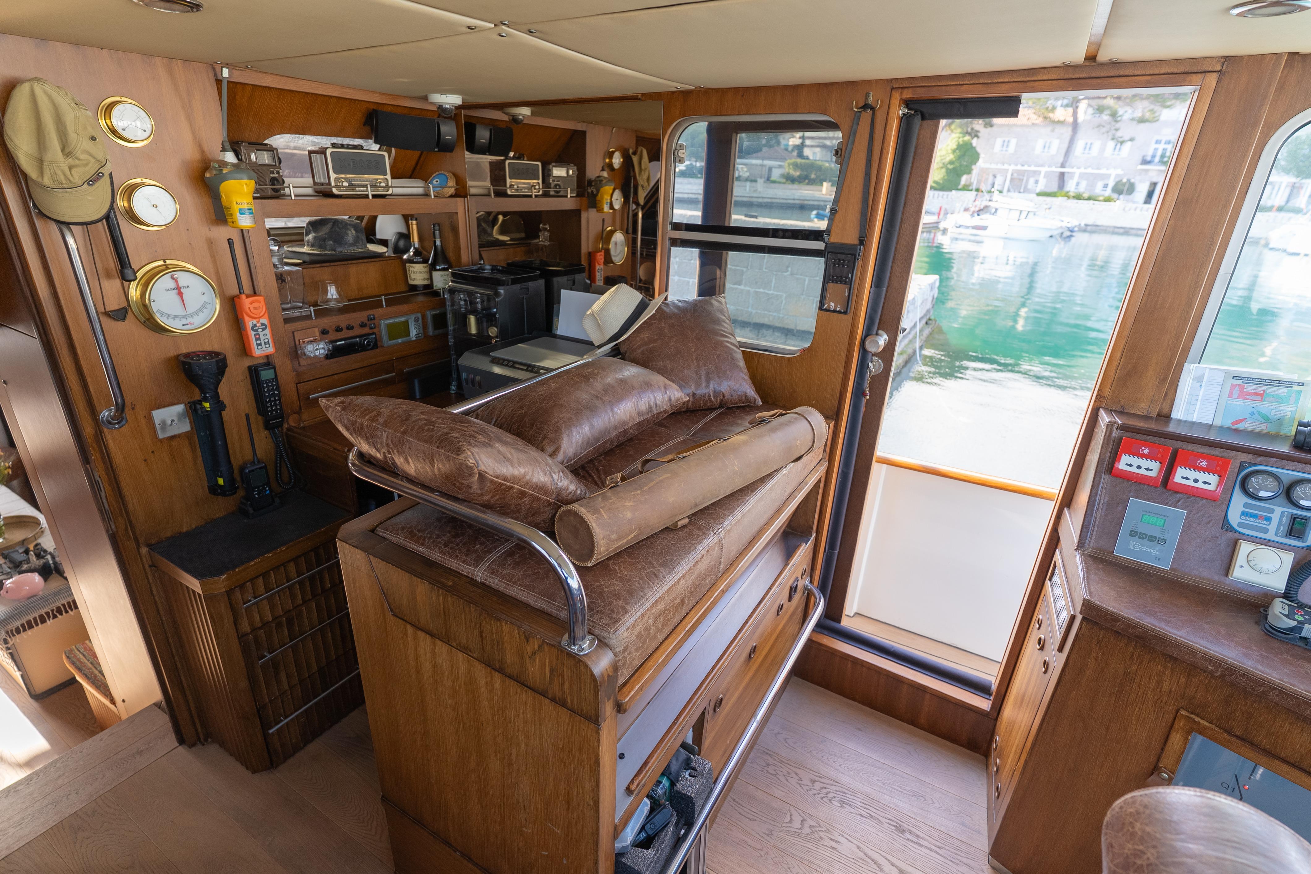 Interior of a 1967 Cammenga 61 yacht with vintage navigation equipment and wooden furnishings.