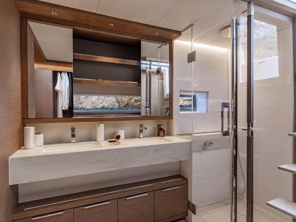 Luxurious bathroom interior of 2025 Lagoon SIXTY 7 yacht with modern fixtures and elegant design.