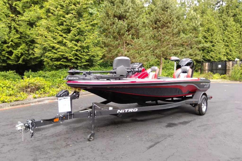 2026 Nitro Z18 Pro fishing boat on trailer, parked near lush green trees.