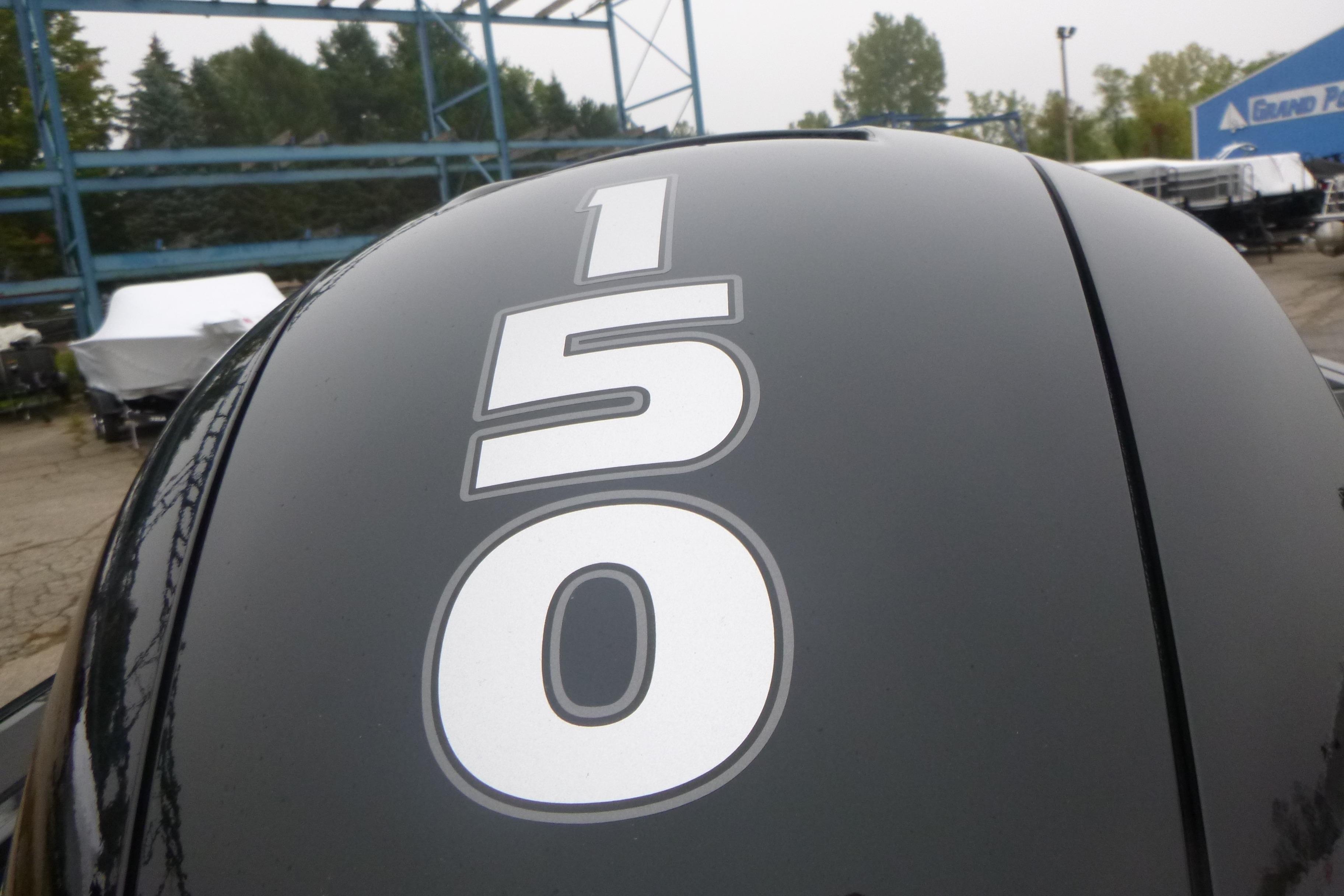 Tracker Targa V-18 Combo 2026 boat engine with '150' decal in outdoor setting.