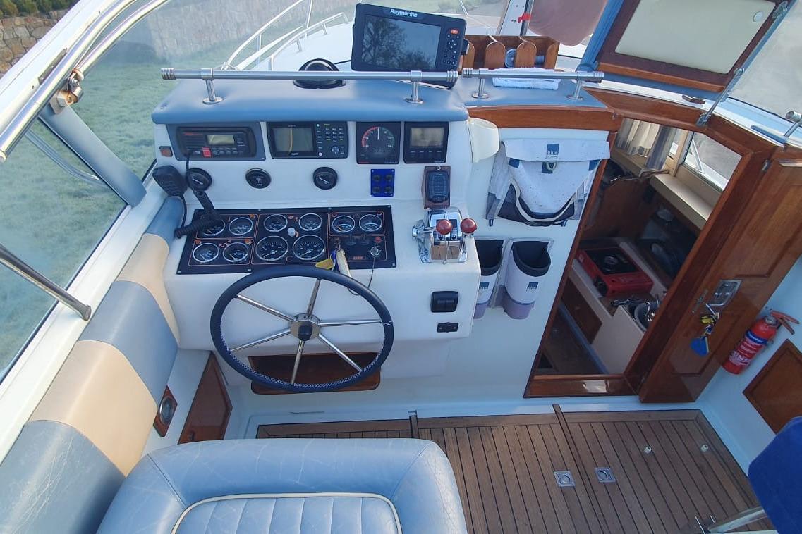 Cockpit of 1989 Fairey Spearfish MKIII boat with steering wheel and navigation instruments.