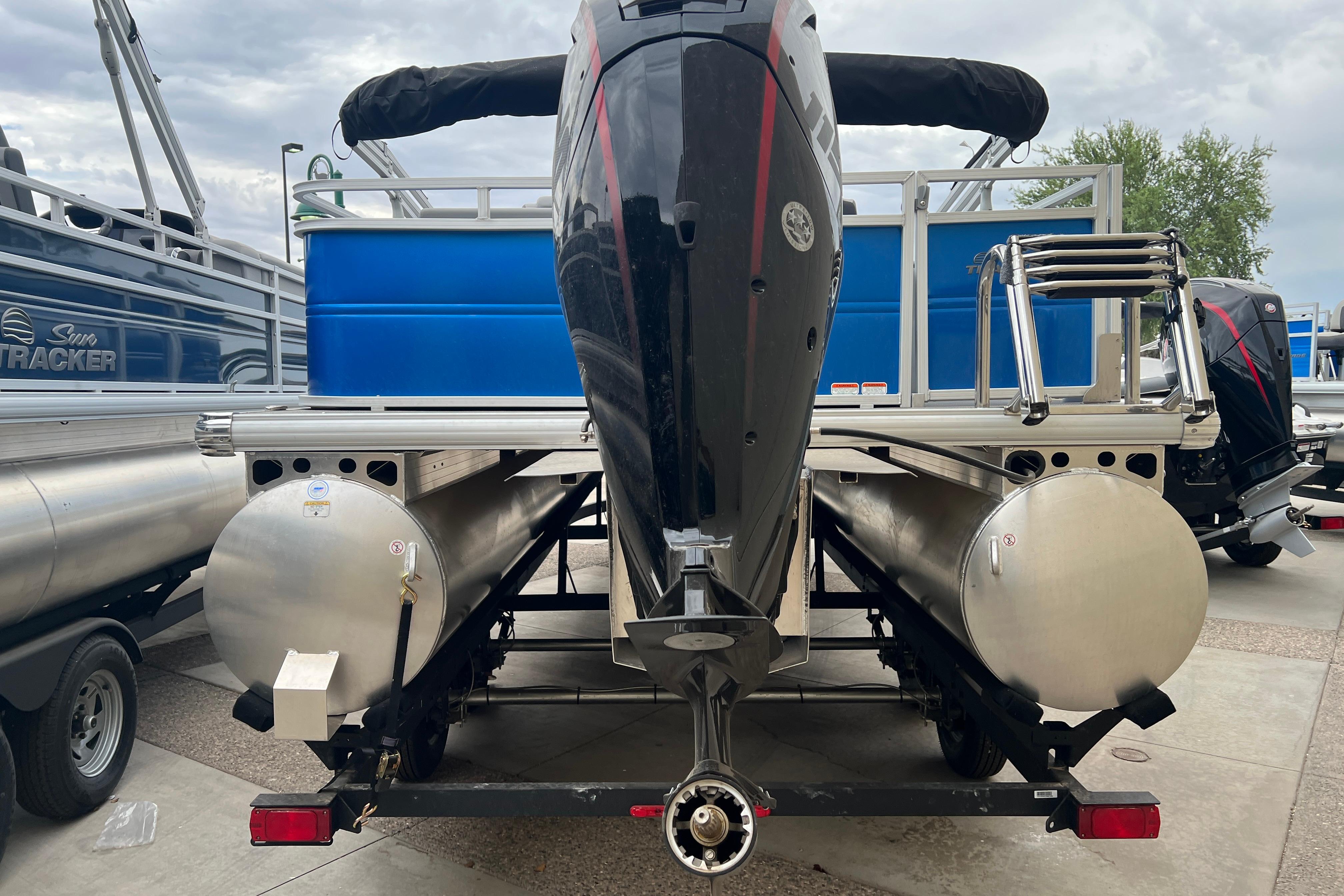 2026 Sun Tracker Party Barge 22 RF DLX pontoon boat rear view with motor.