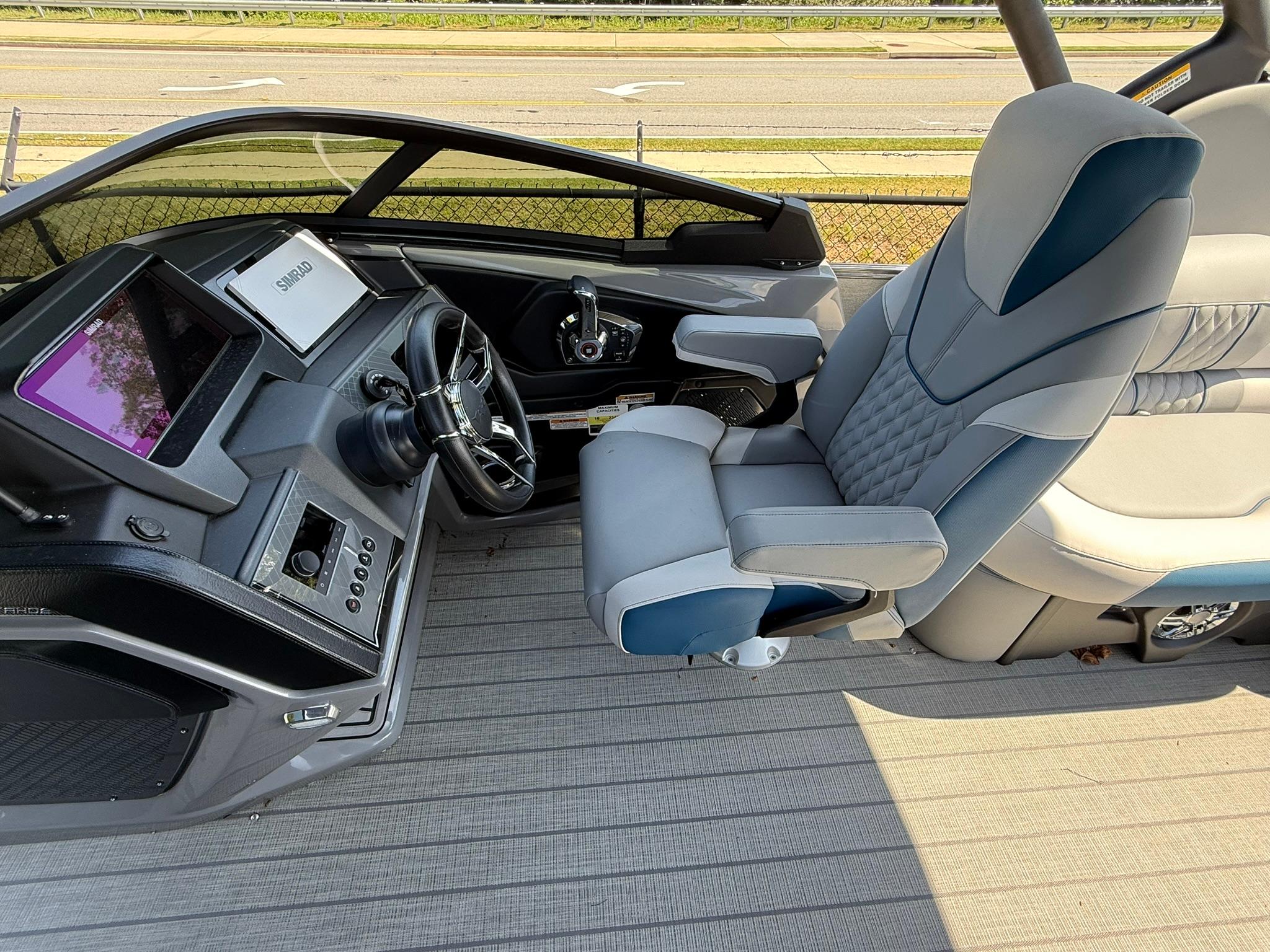 2025 Tahoe Pontoon Grand Tahoe Elite Windshield helm with modern controls and luxurious seating.