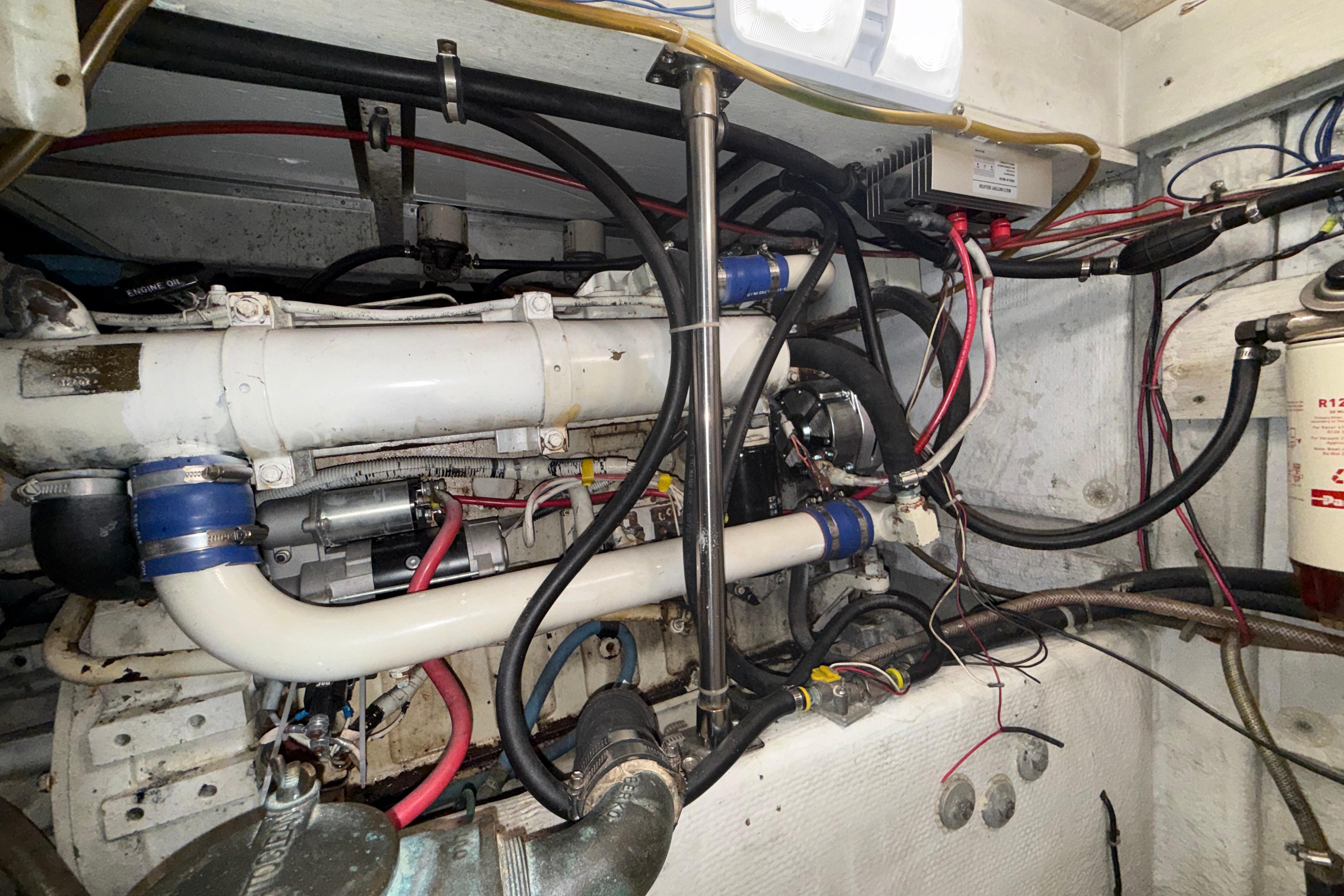 Engine room of a 1997 Bayliner 3988 Command Bridge Motoryacht, showcasing complex wiring and components.