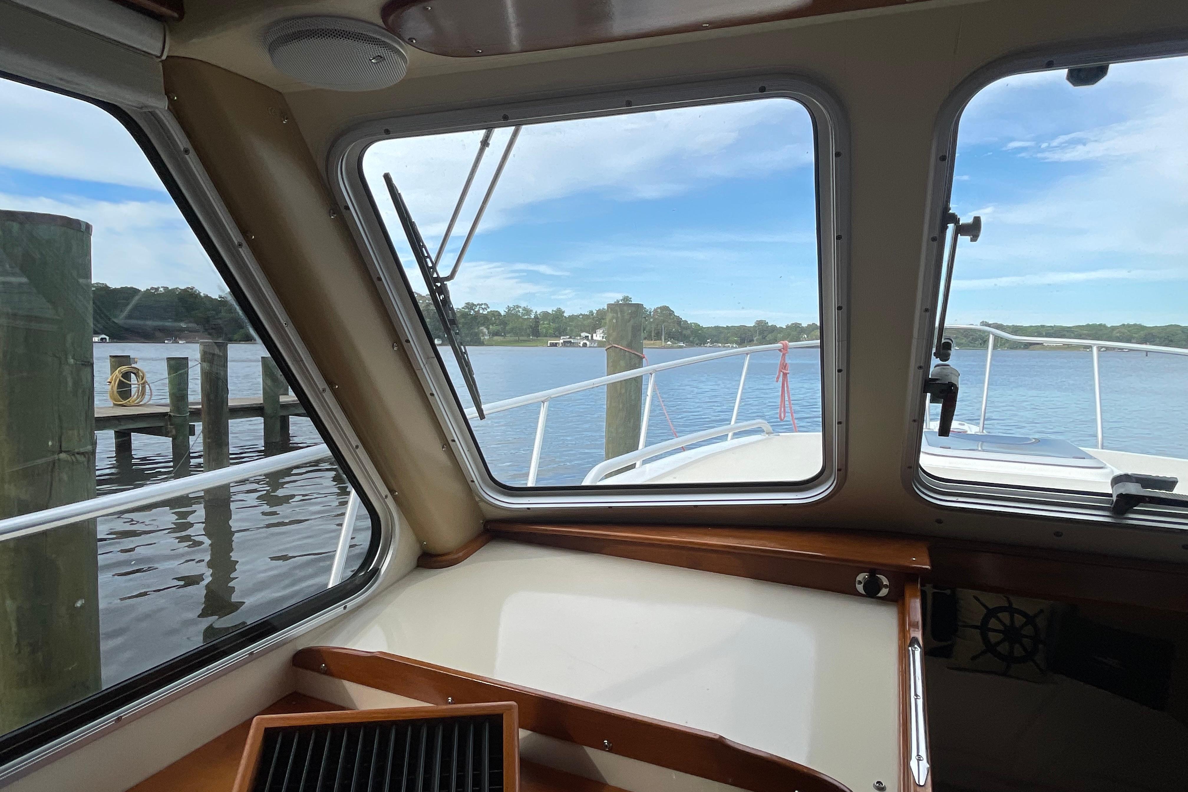 Interior view from a 2005 Fox Island Thirty Sedan Cruiser, overlooking a serene waterfront.