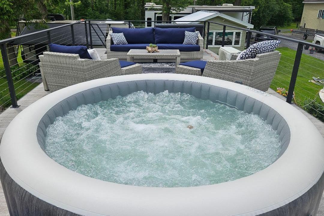 Outdoor hot tub on East Coast Houseboats Freedom 40, 2021 model, with patio seating.