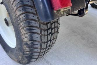 Close-up of a 2012 Avalon Tahoe tire on a concrete surface.