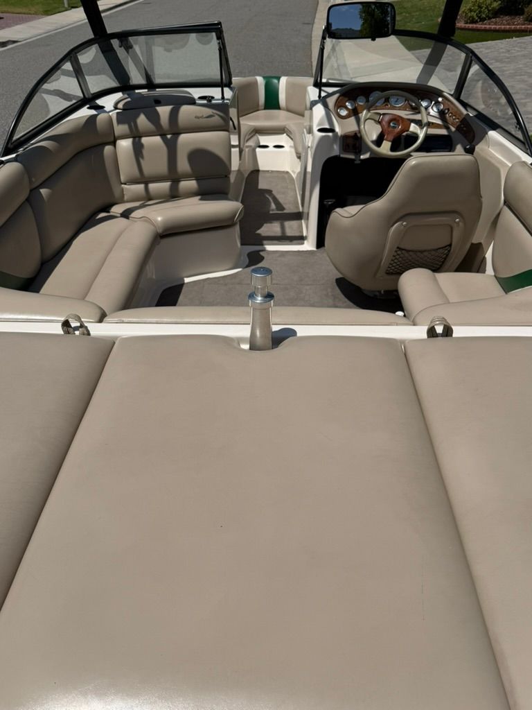Interior view of a Tigé 21V boat with beige seating and steering wheel.