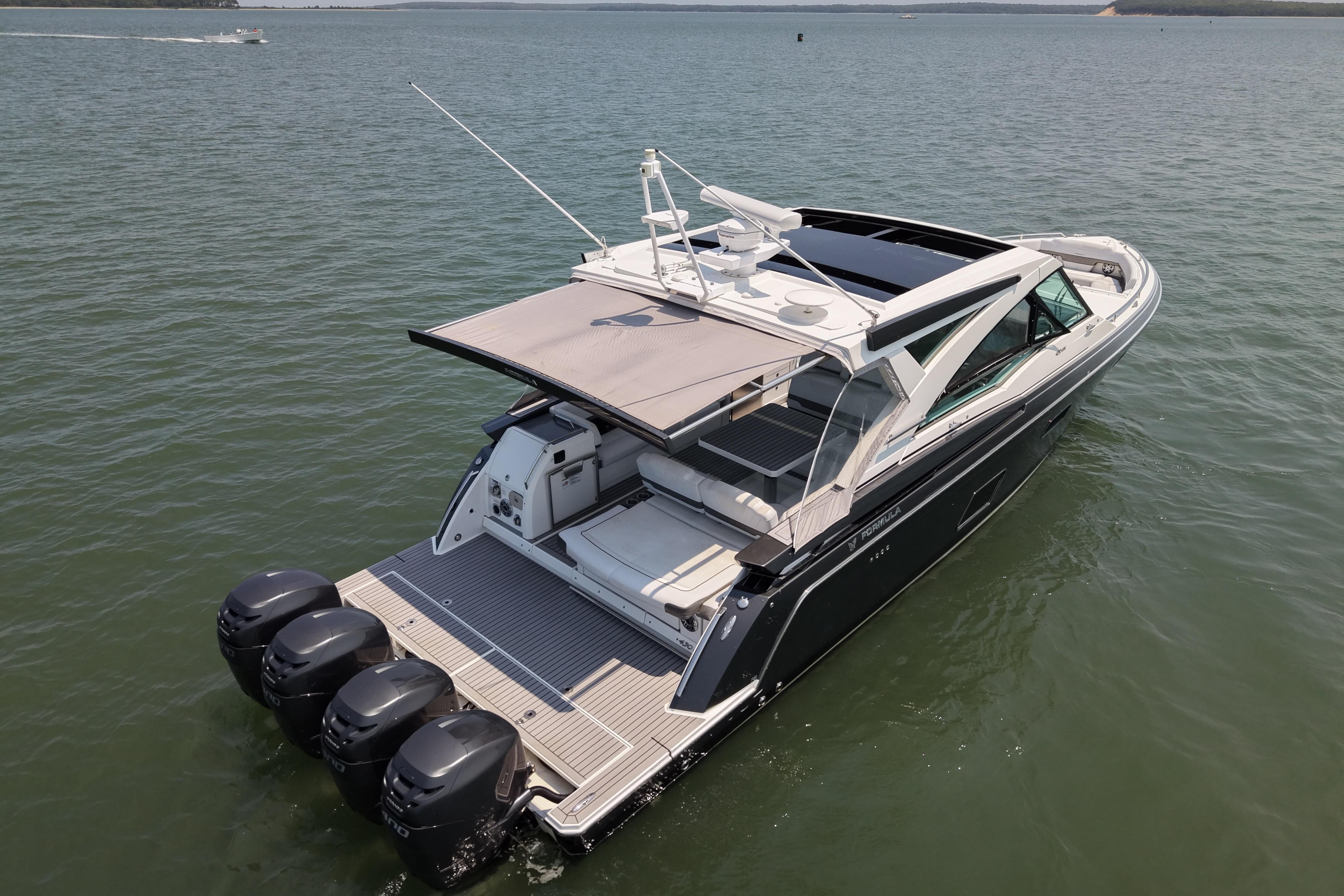 2019 Formula 430 Super Sport Crossover boat on calm water, featuring multiple outboard engines.