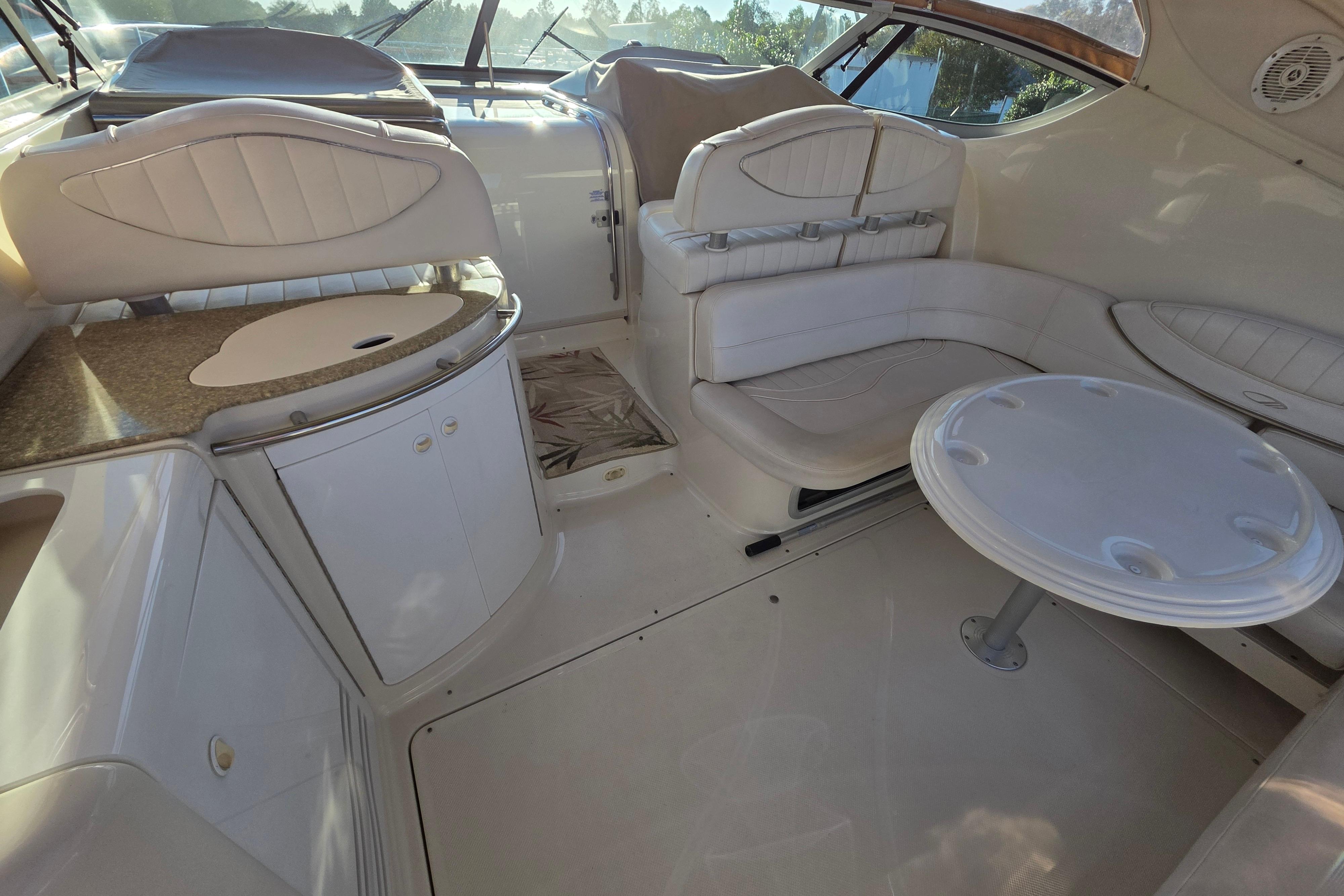 1998 Maxum 3700 SCR yacht interior with white seating and table.
