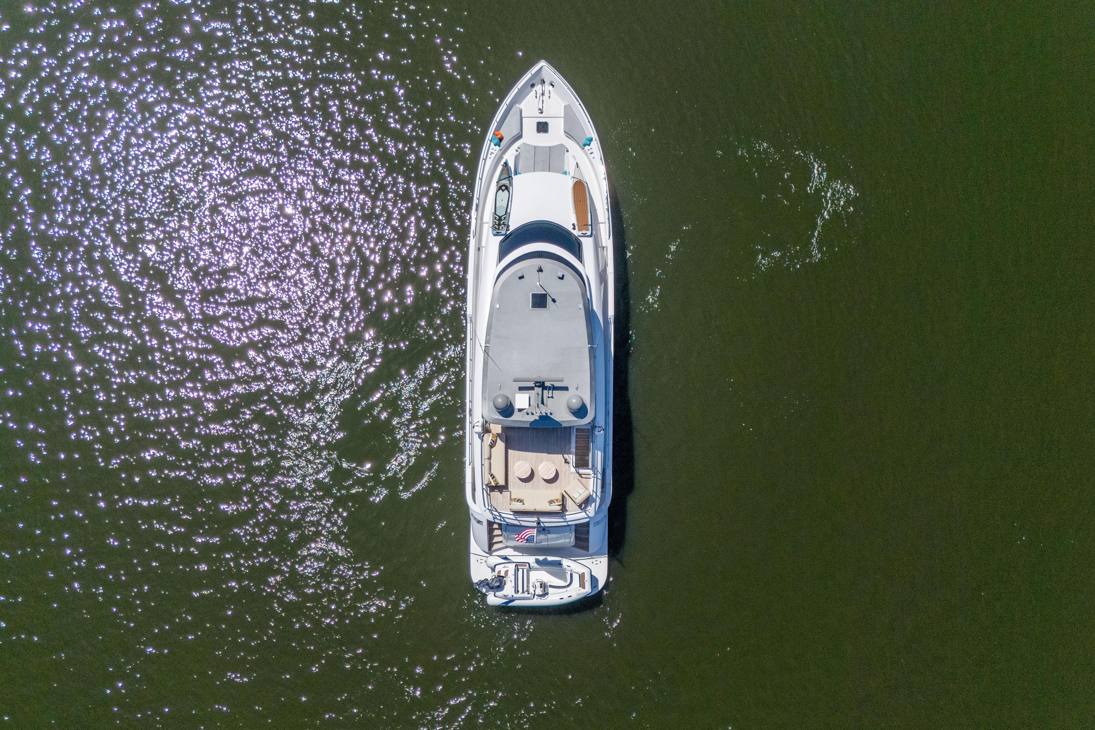 Aerial view of 2021 Hatteras M75 Panacera yacht on shimmering water.