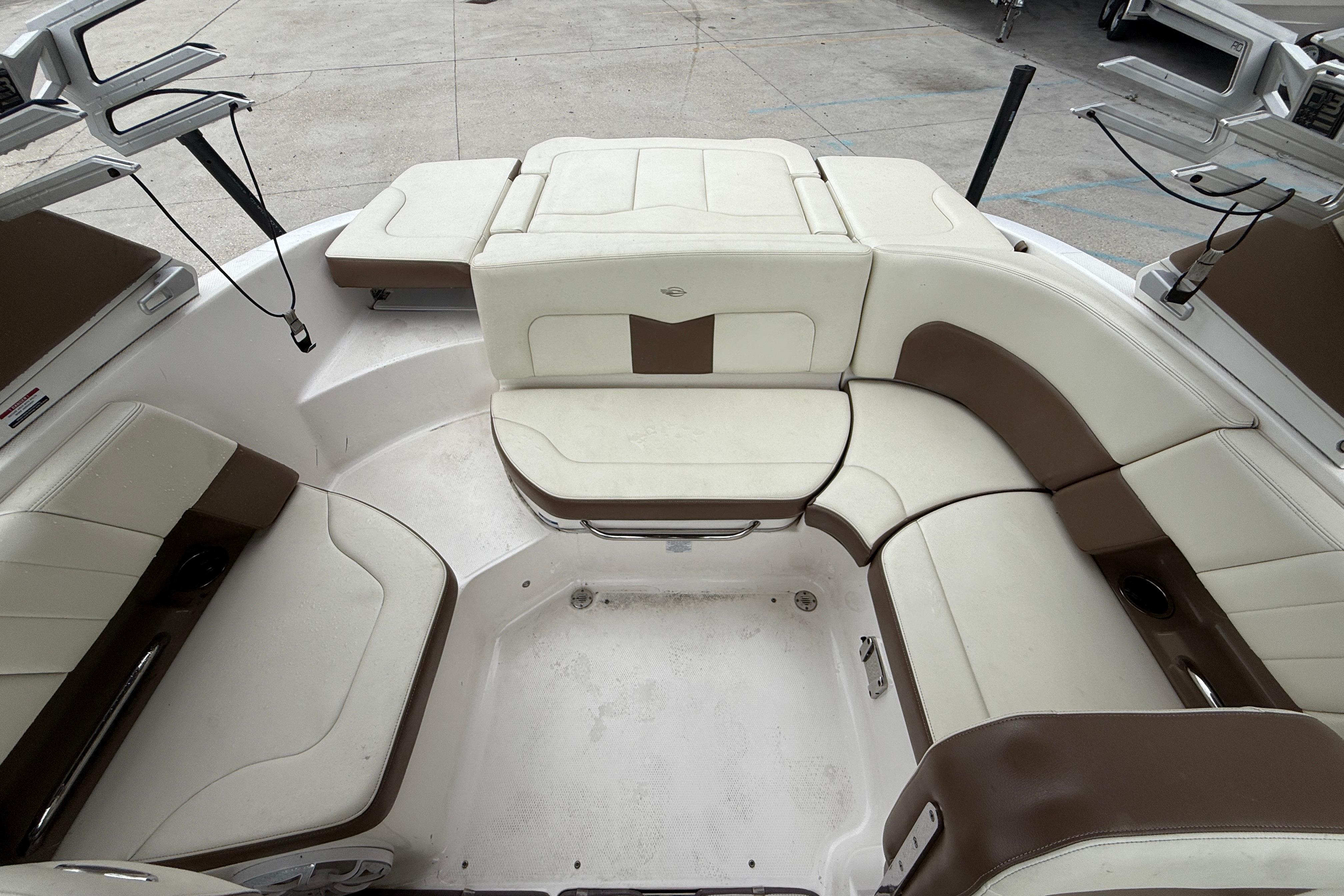 Interior seating of 2018 Chaparral 227 SSX Surf boat, featuring white and brown upholstery.