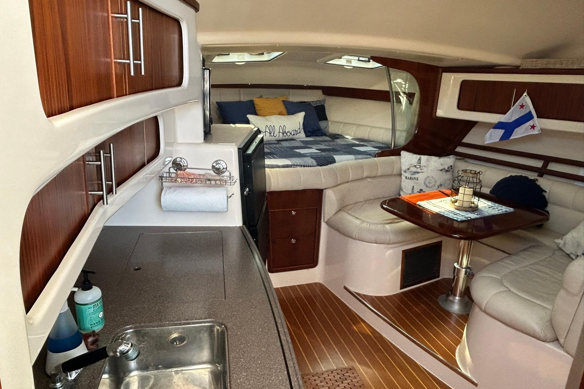 Luxurious 2007 Grady-White Express 360 cabin interior with kitchenette and cozy seating area.