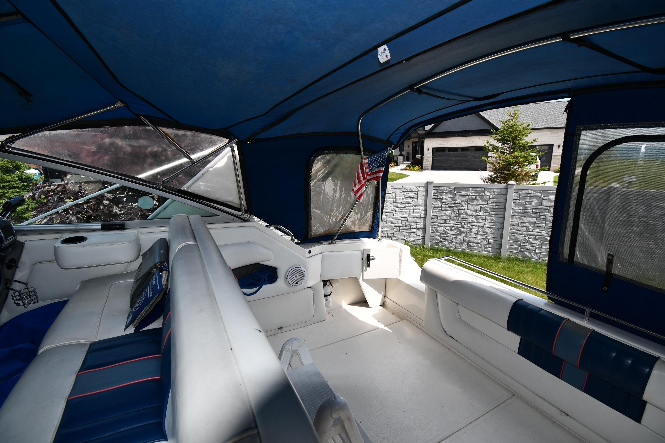 Interior of a 1993 Sea Ray 300 Sundancer boat with blue canopy and seating.