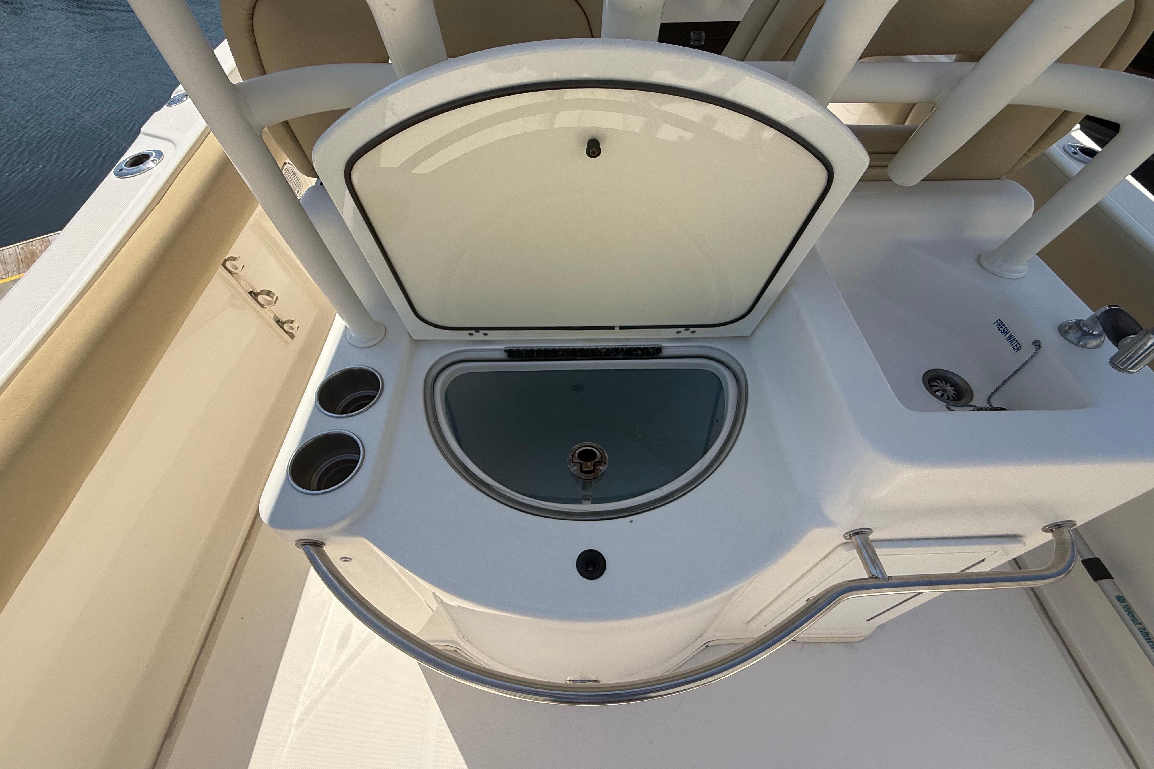 2019 Key West Billistic 281 Center Console boat with open storage compartment.