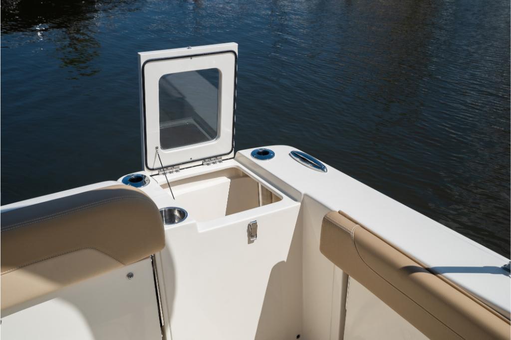 2023 Scout 240 Dorado boat interior with open storage compartment by the water.