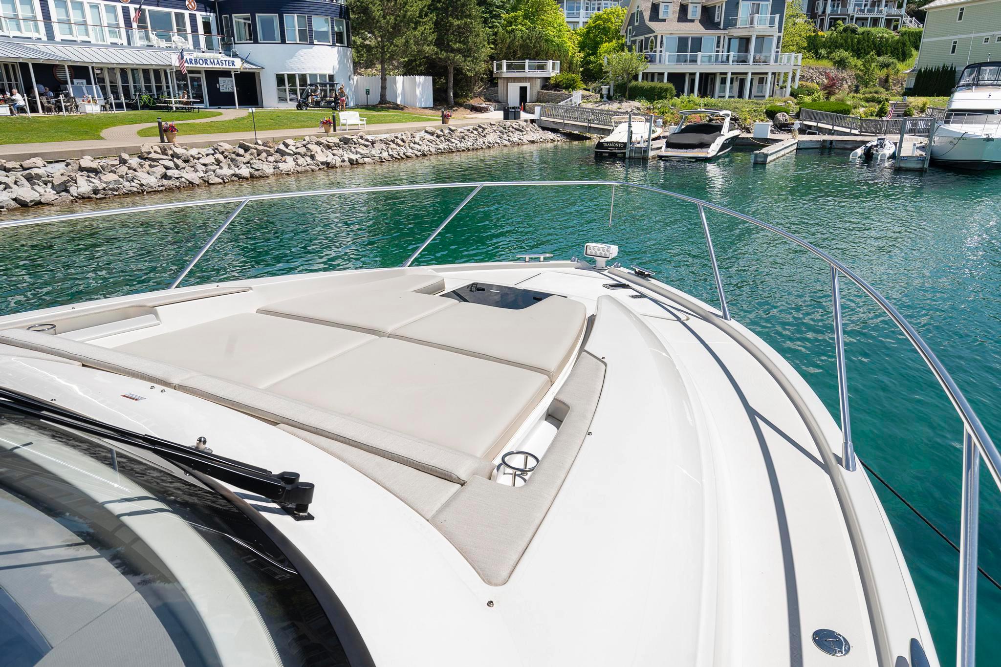 2022 Tiara Yachts C49 Coupe docked in a scenic marina setting.