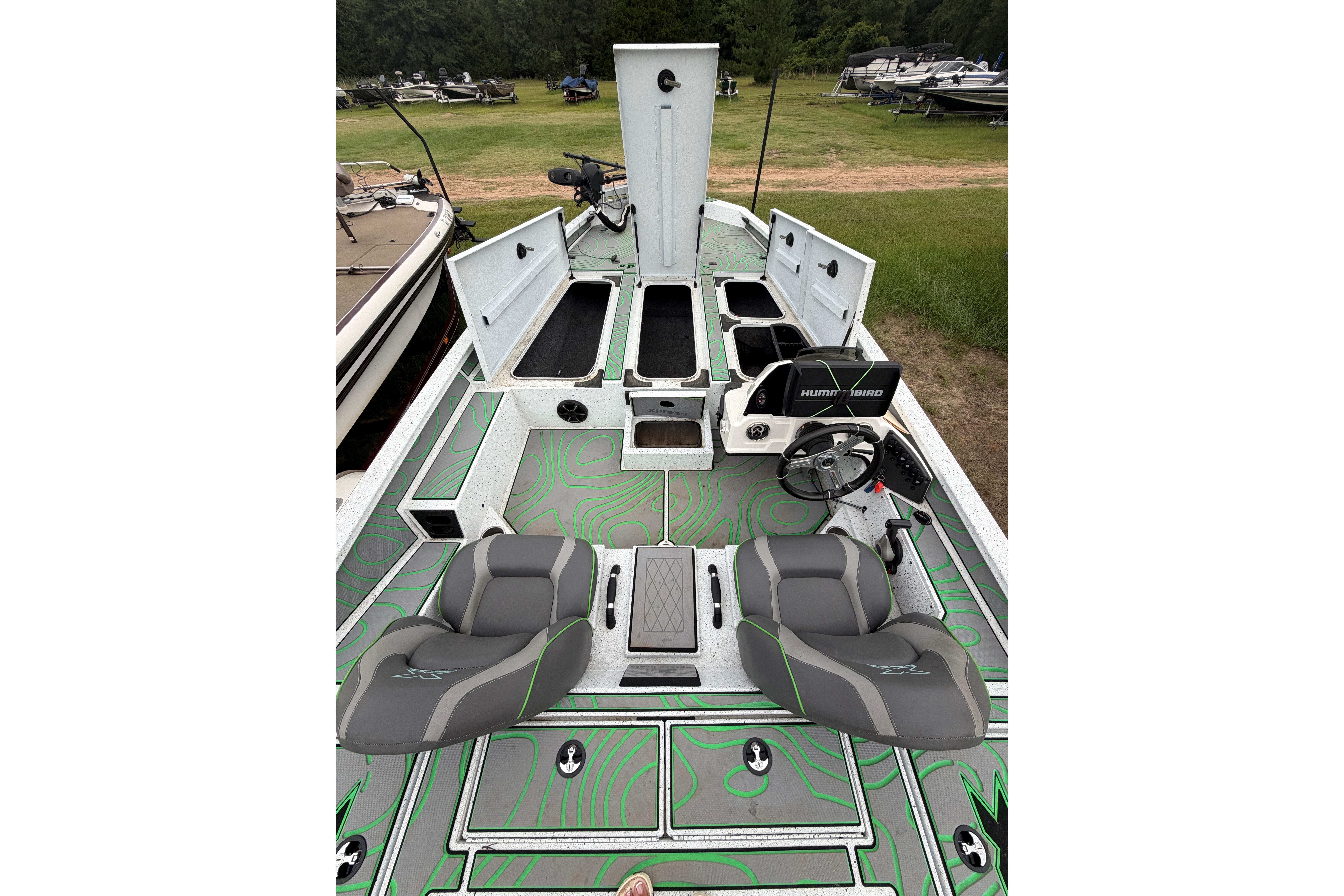 2022 Xpress X21 Pro boat interior with open storage compartments and seating.