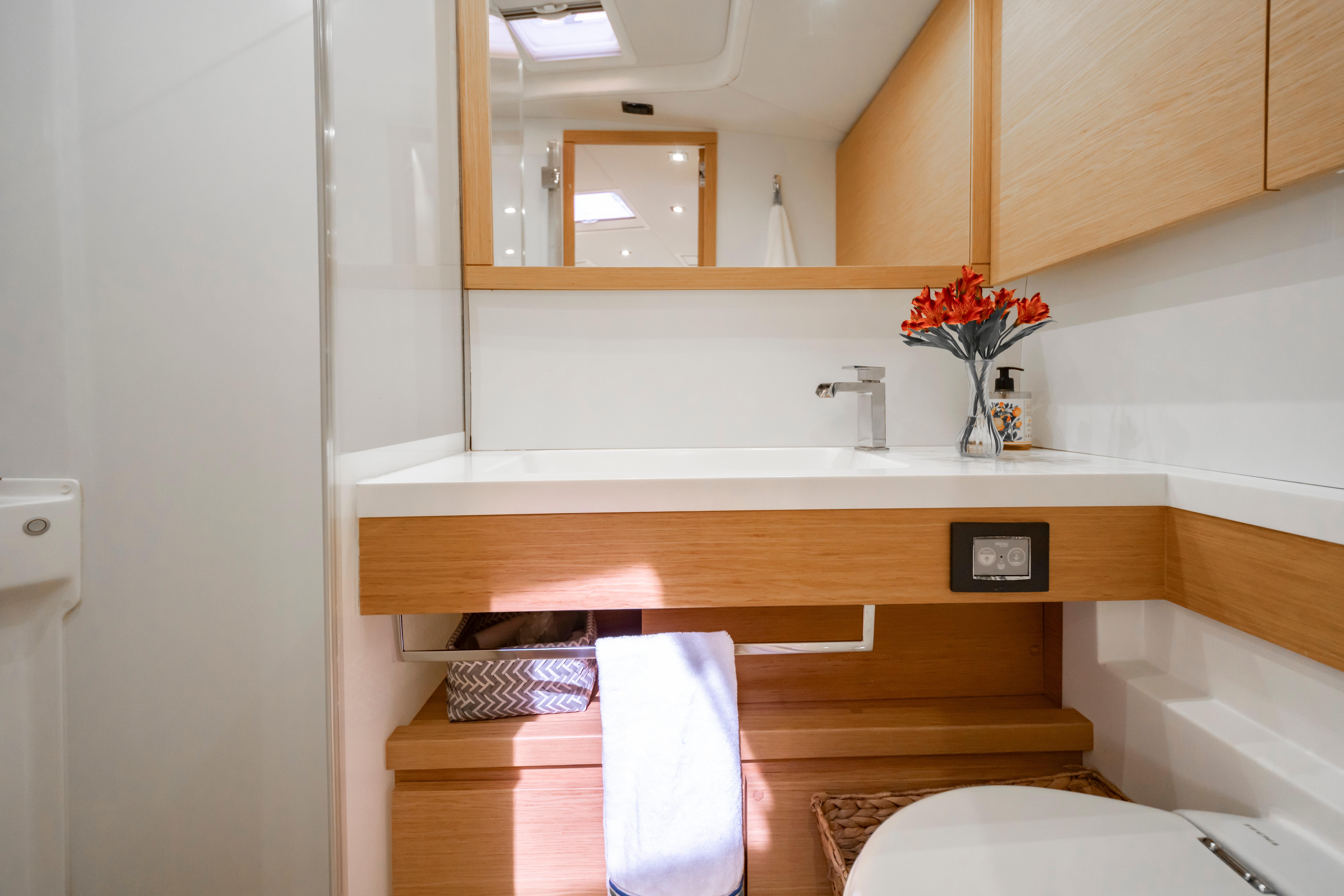 Luxurious bathroom interior of 2016 Grand Soleil 58 yacht with modern fixtures and wooden accents.