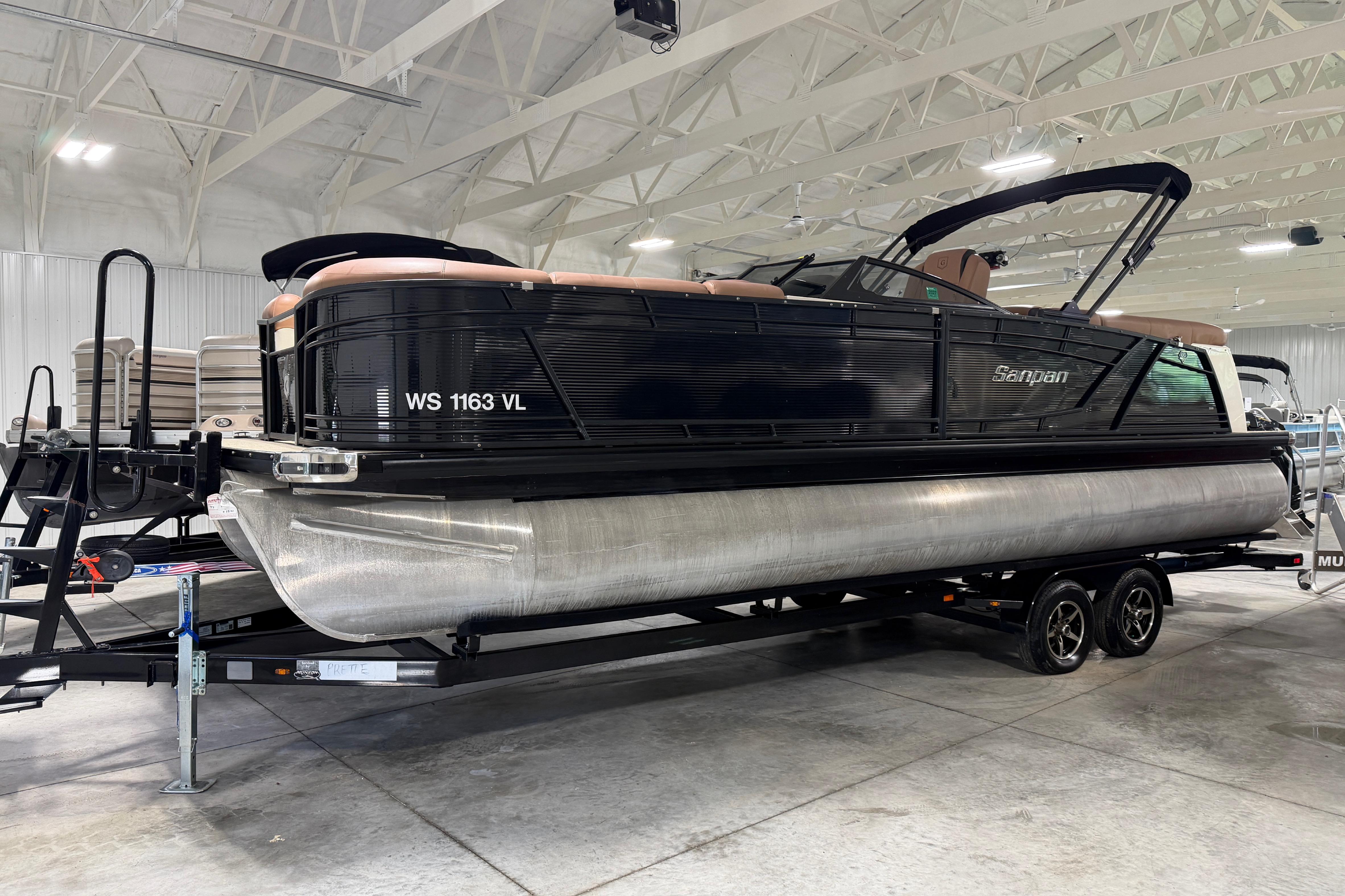 2018 Godfrey Sanpan 2500 ULC pontoon boat on trailer in indoor showroom.