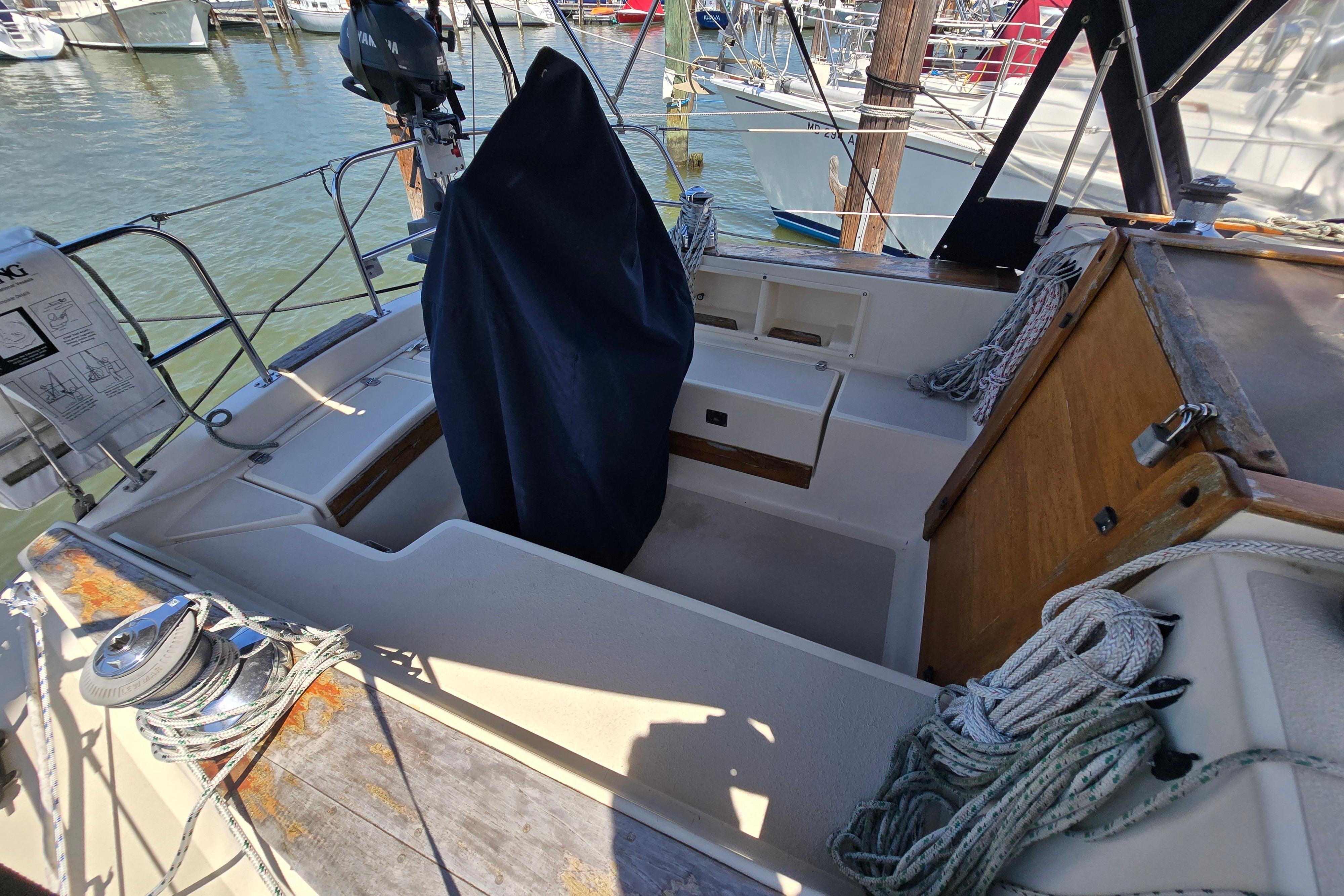 Cockpit of a 1993 Caliber 35 sailboat with ropes and covered equipment.