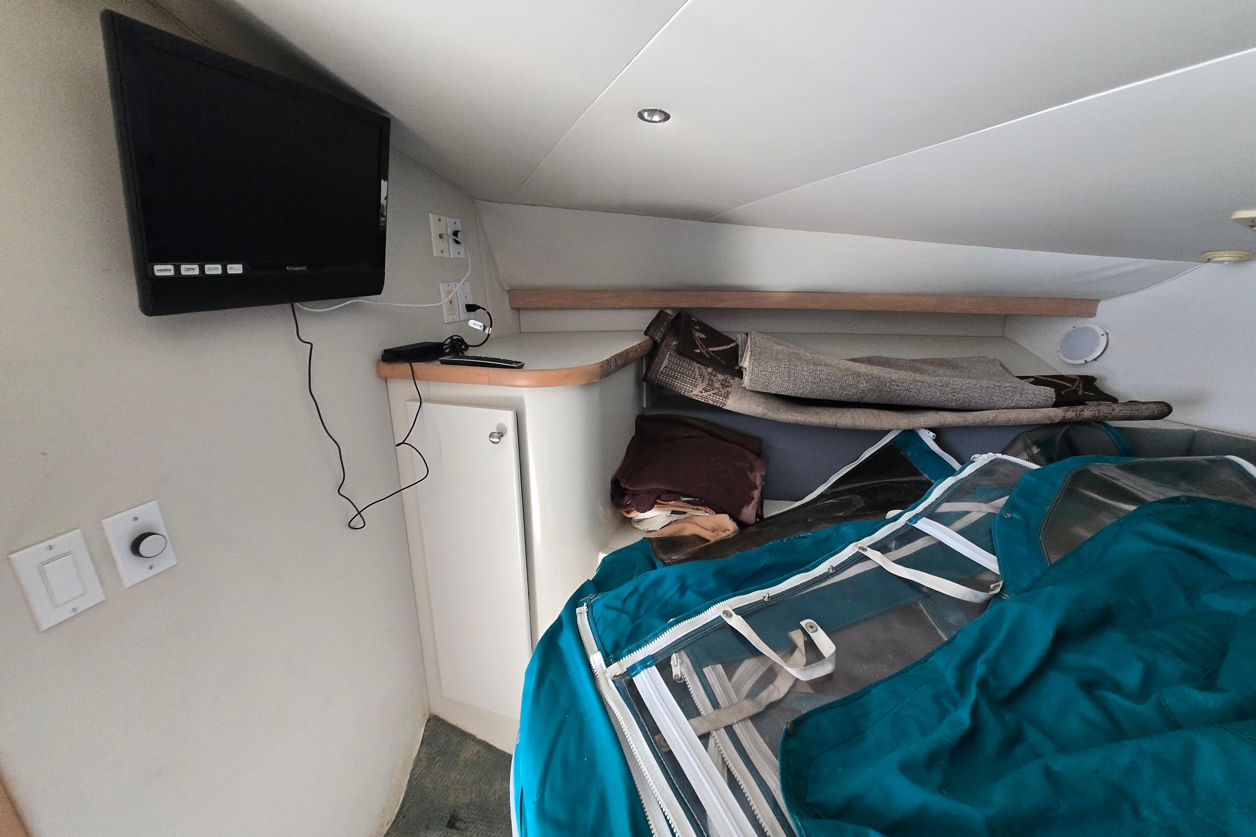 Interior of 1994 Carver 380 Santego boat with TV and storage area.