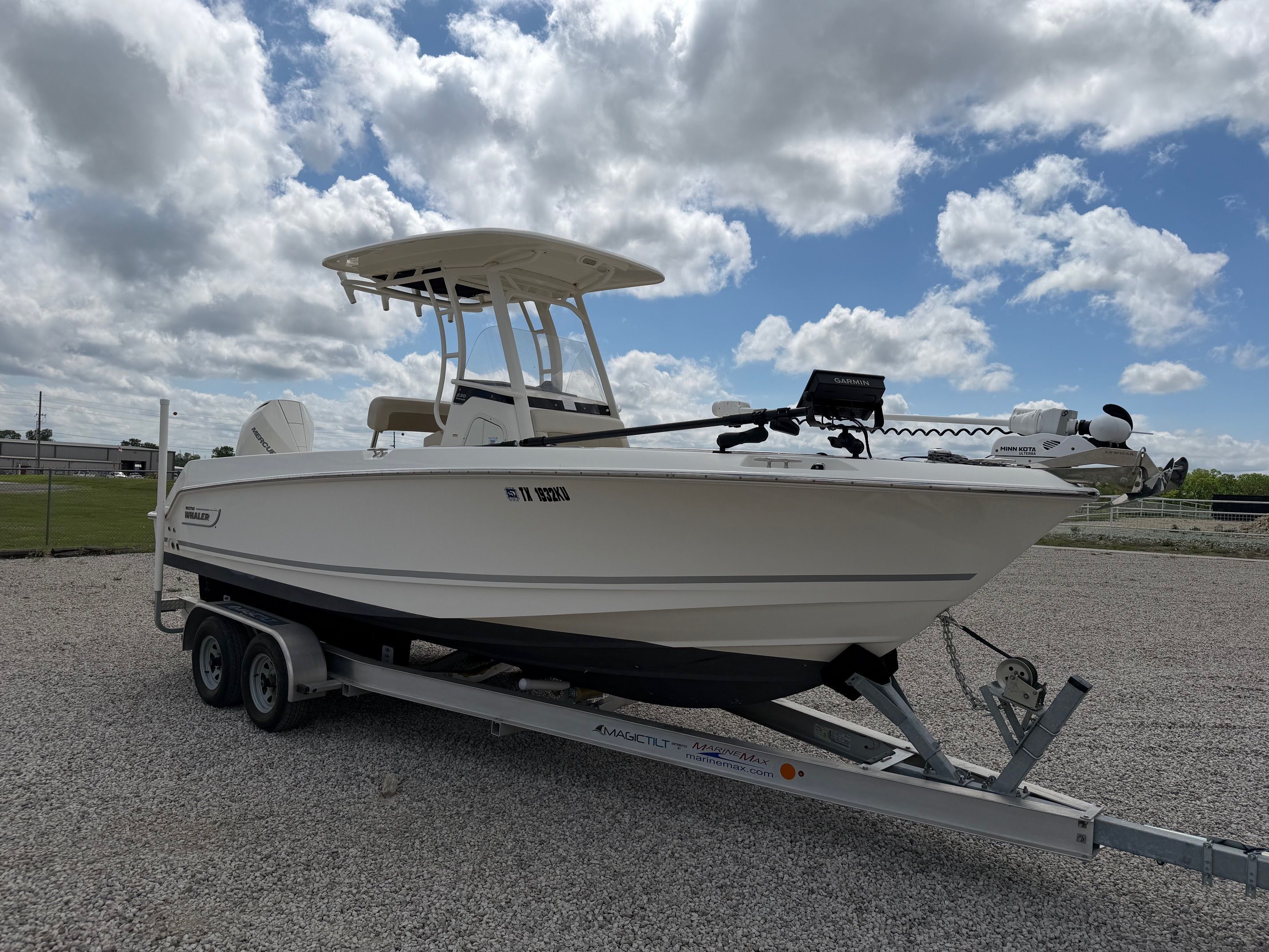 Boston Whaler 230 Outrage 2020 on trailer under cloudy sky.