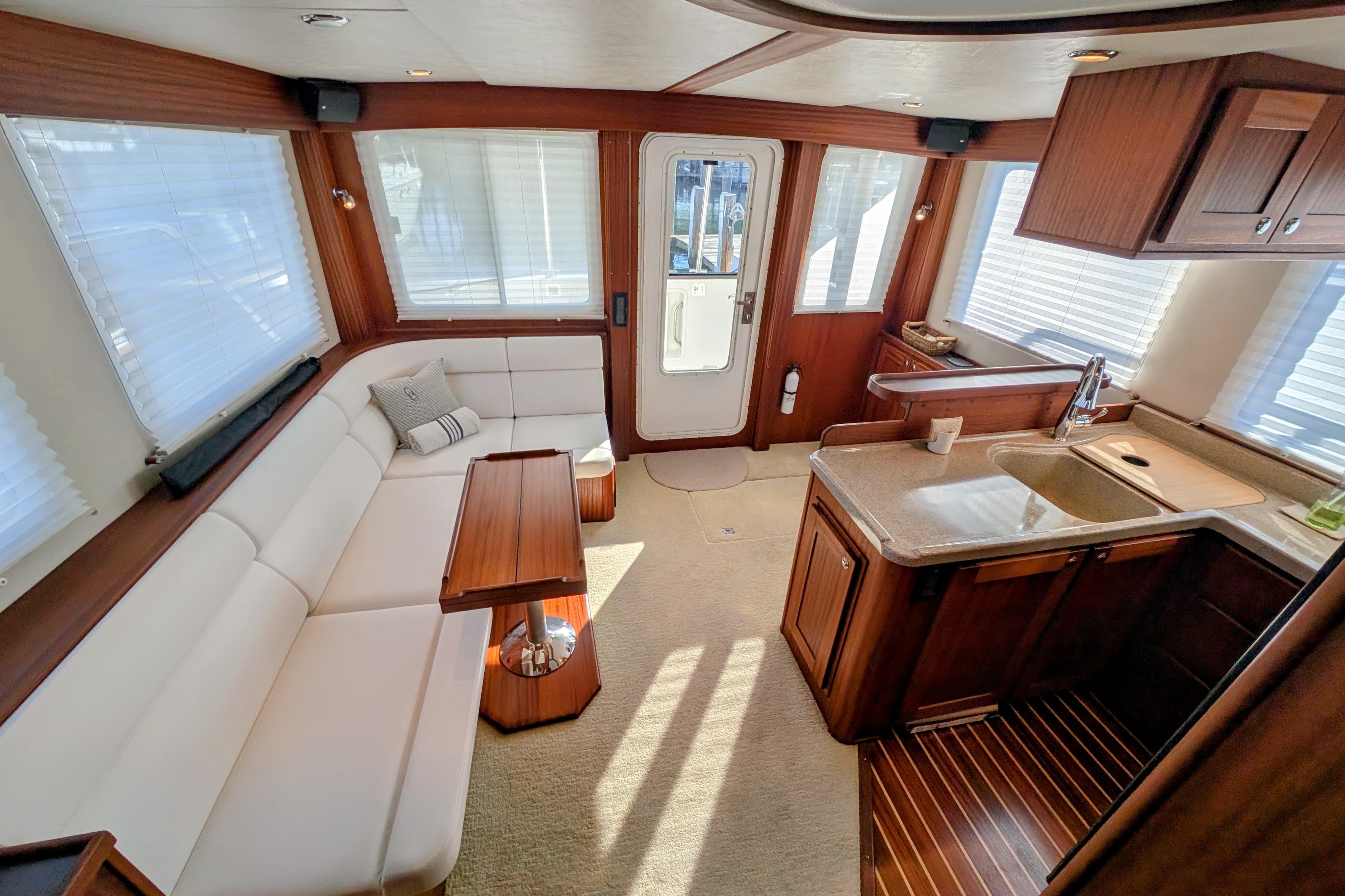 Luxurious interior of 2015 American Tug 435 with elegant seating and modern kitchen area.