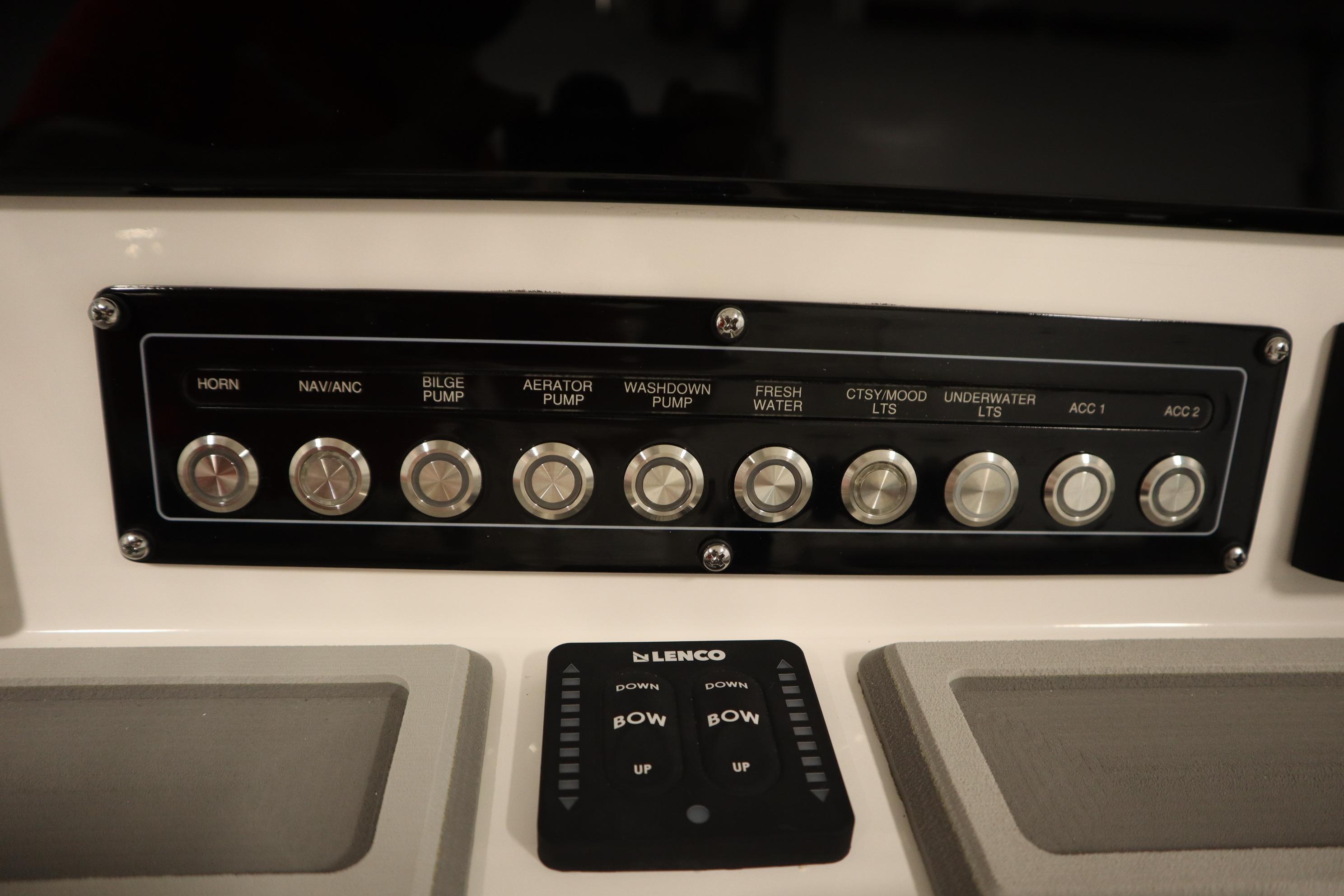 Control panel of 2026 Sea Fox 228 Commander boat with various switches and buttons.