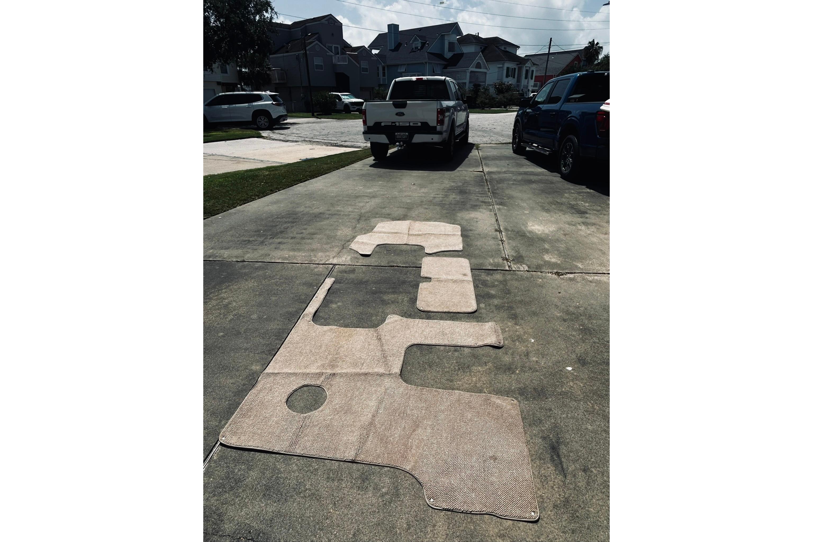 Outdoor driveway with boat carpet pieces for 2013 Hurricane SunDeck Sport 201 OB.