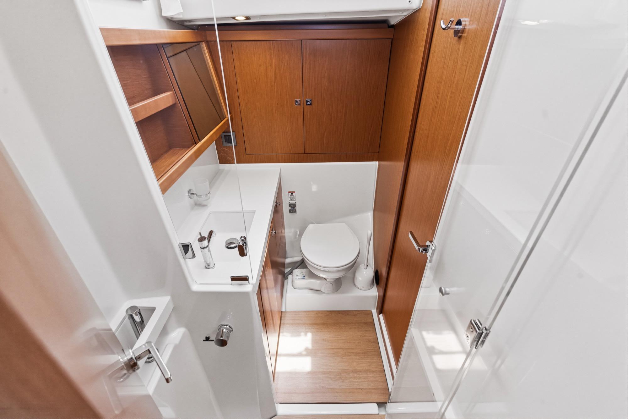 2017 Beneteau Sense 50 yacht bathroom with modern fixtures and wooden cabinetry.