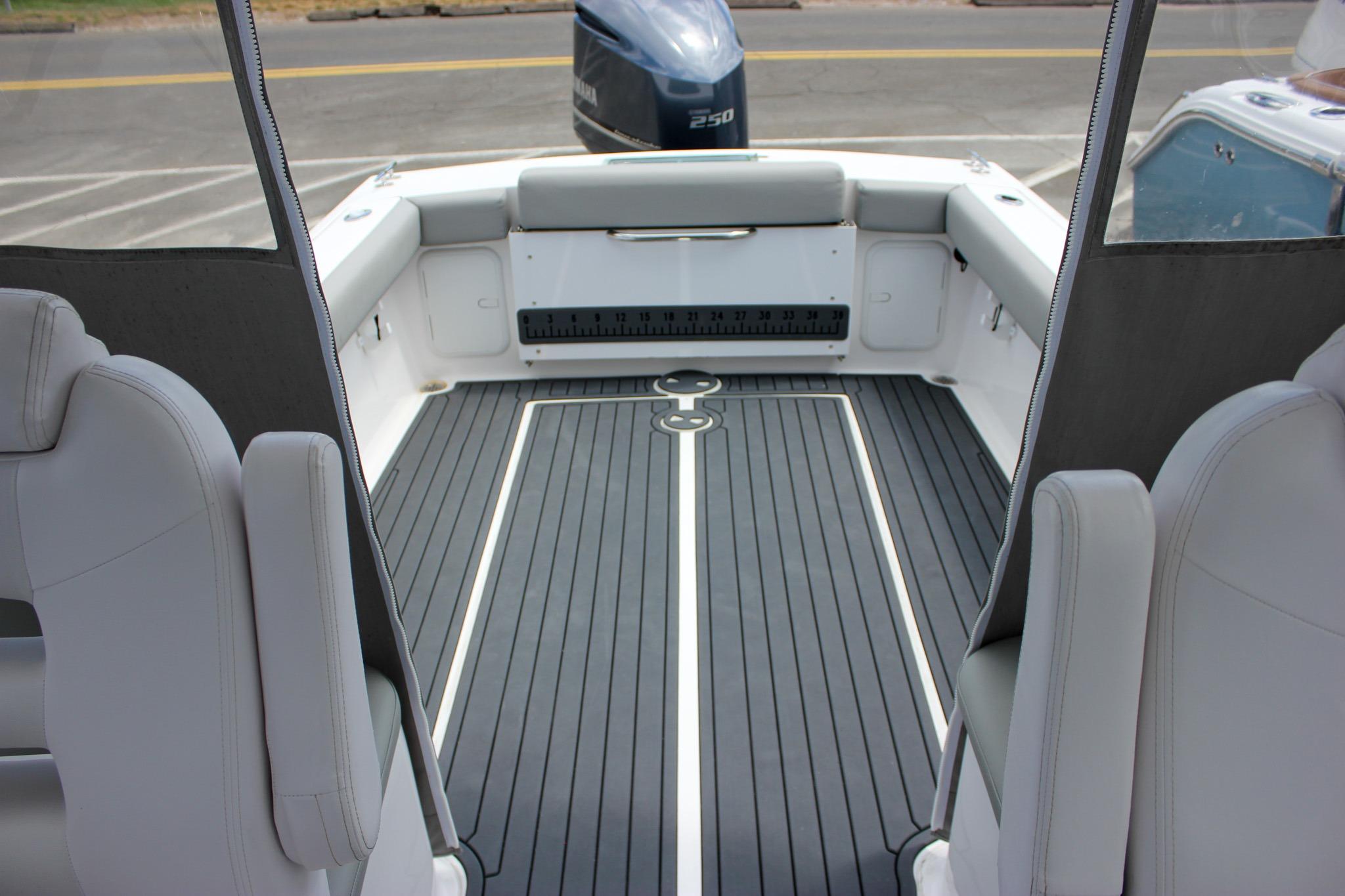 2022 NorthCoast 235 Cabin boat interior with sleek seating and modern flooring.