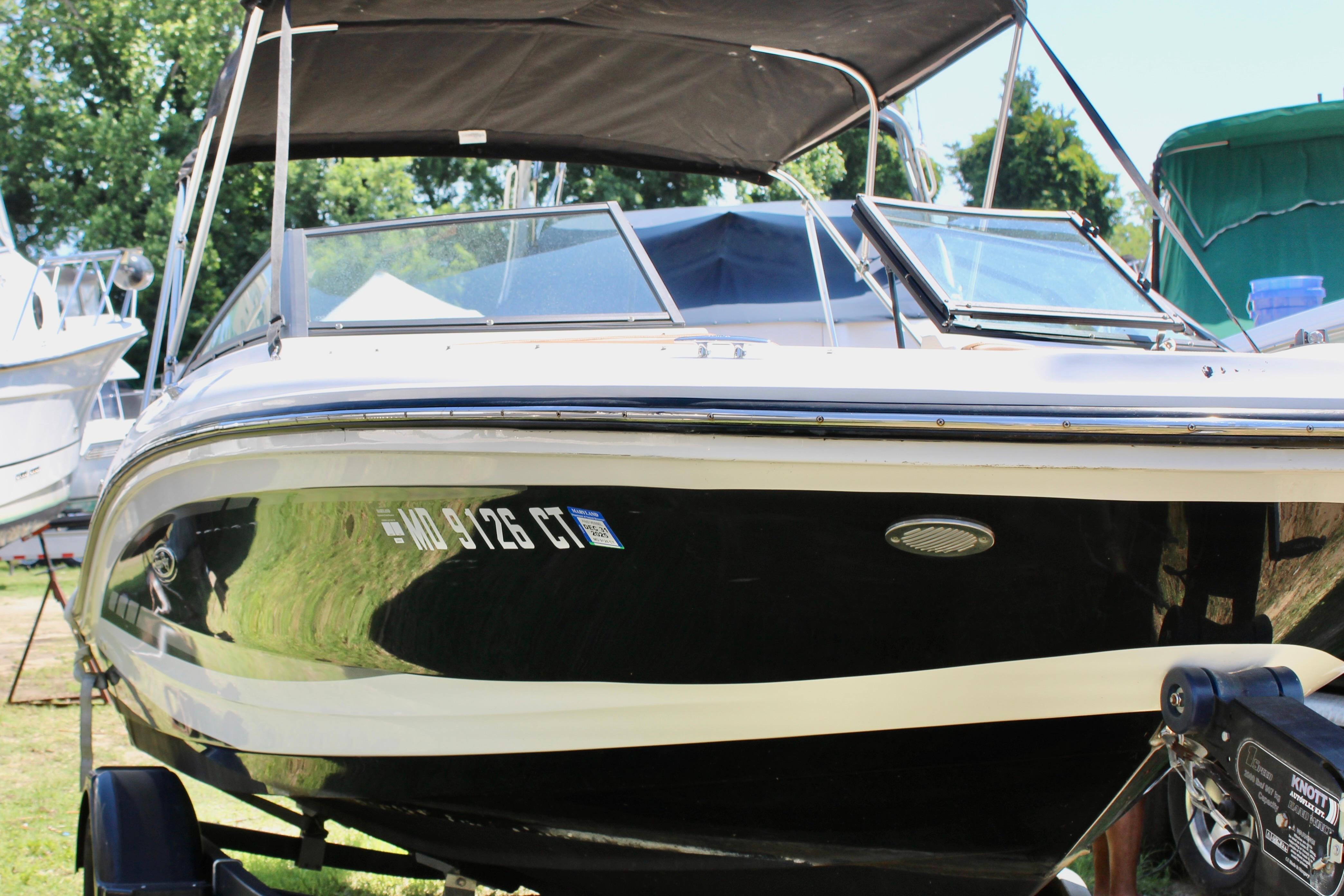 2018 Sea Ray SPX 190 Outboard boat with black hull, parked on a trailer.