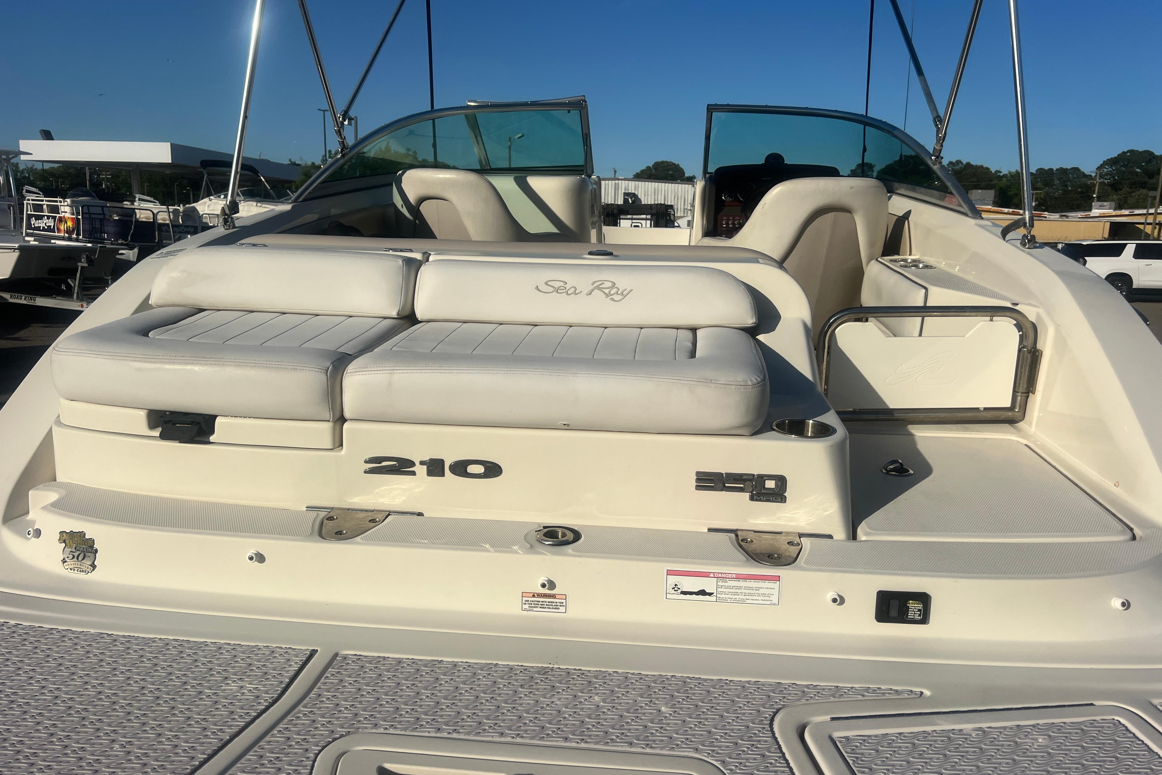 2009 Sea Ray 210 Sundeck boat with white seating and sleek design.