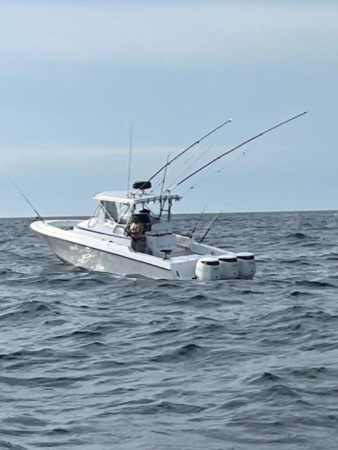2006 Contender 36 Fisharound boat on open sea with fishing rods.