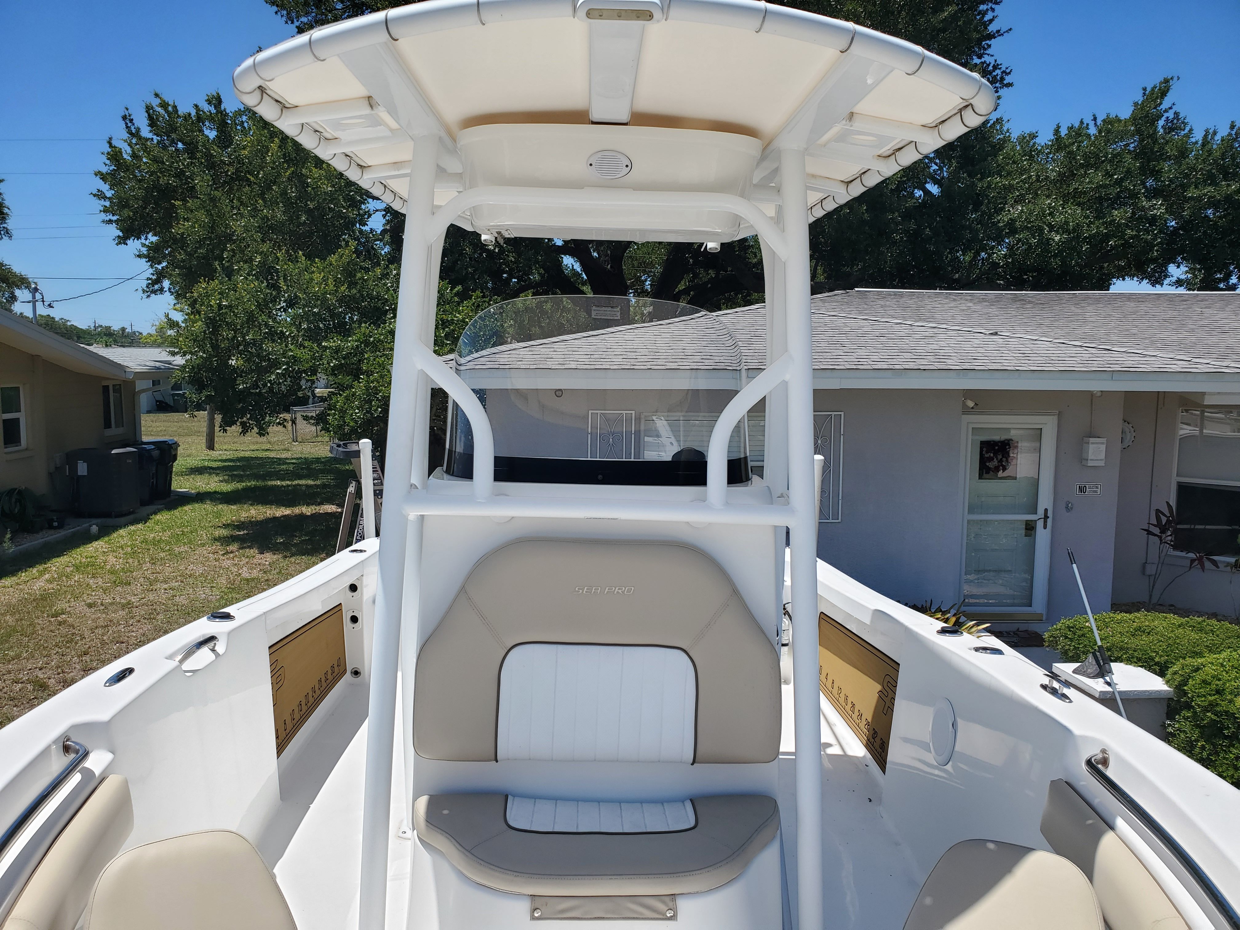 2017 Sea Pro 219 Center Console with spacious deck and T-top, parked outdoors.