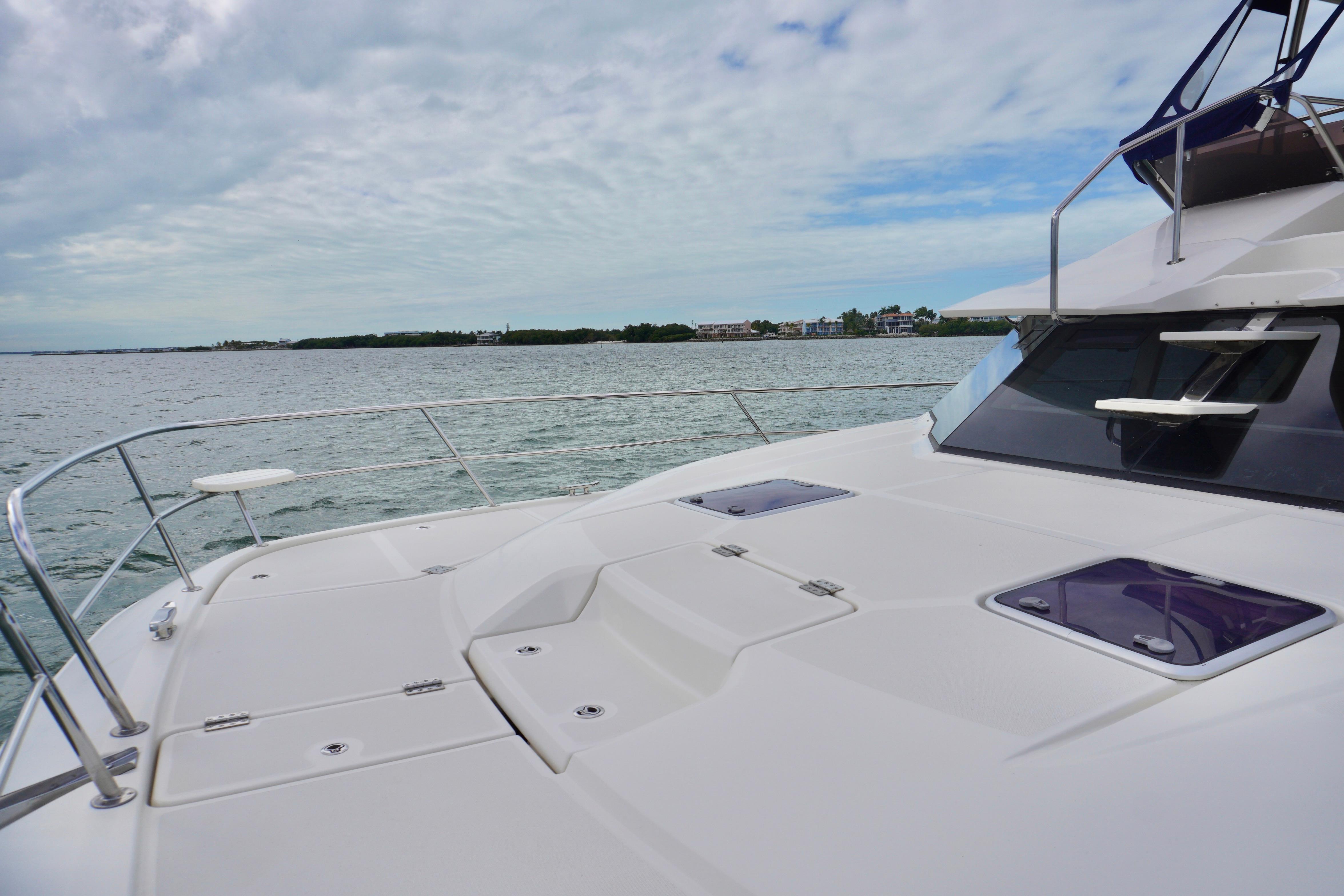 2017 Aquila 44 Yacht deck with ocean view under cloudy sky.