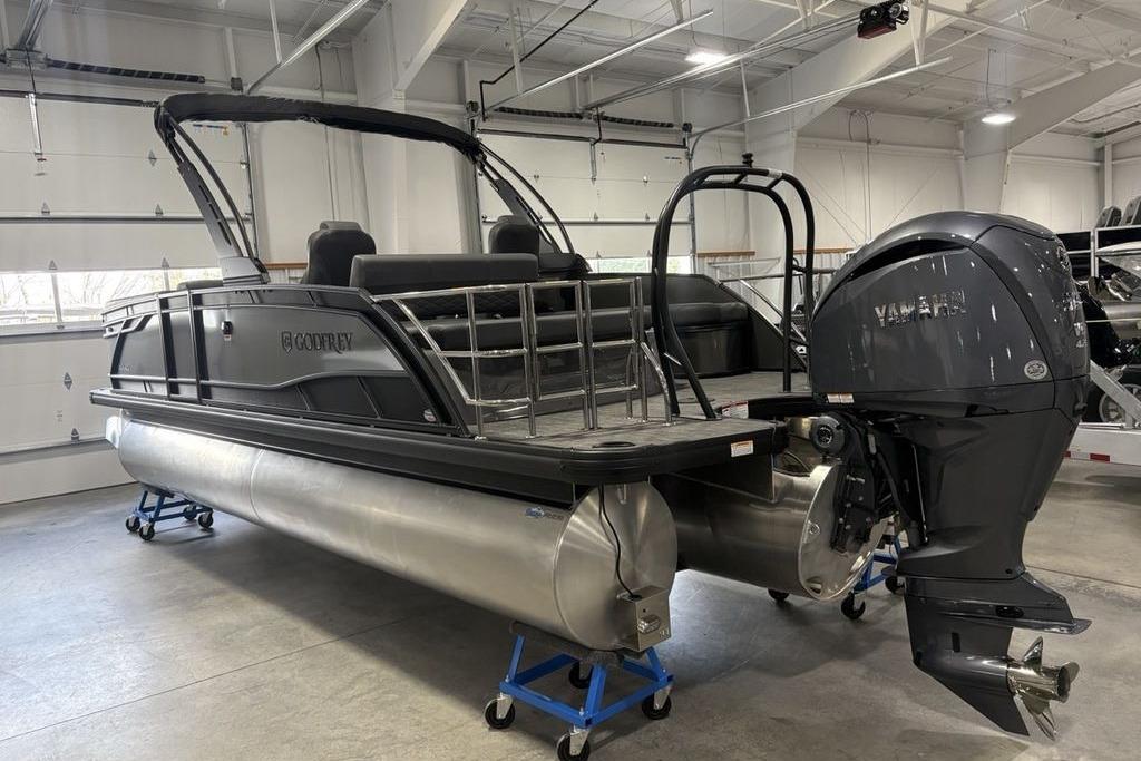 2026 Godfrey Monaco 235 SFLC iMPACT 2.0 pontoon boat in showroom with Yamaha engine.