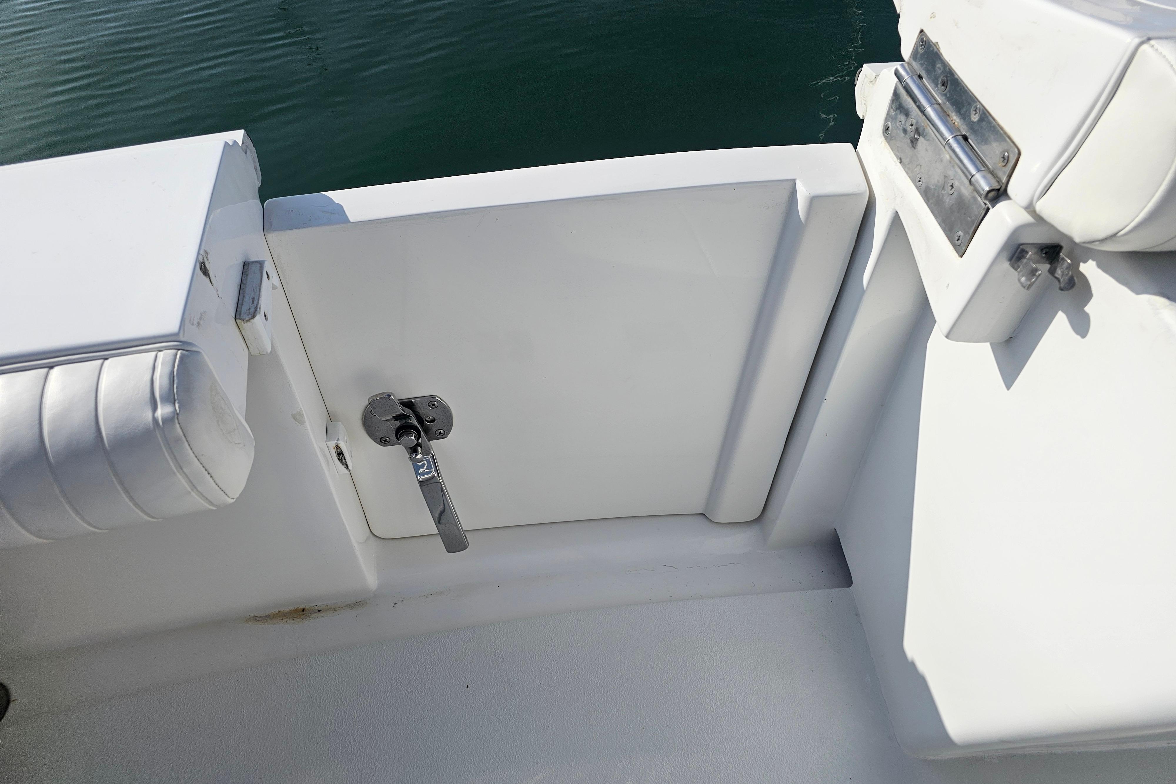 2003 Topaz 32 Express boat interior with white seating and latch detail.