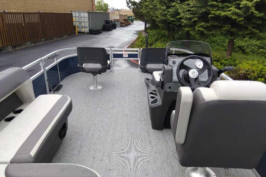 2026 Sun Tracker Bass Buggy 16 XL Select pontoon boat interior with seating and steering console.