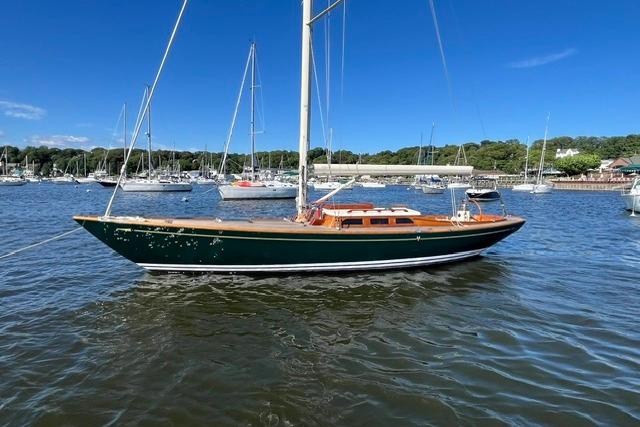 Sailboat on water, Morris 36 model, 2006, with clear blue sky and marina background.