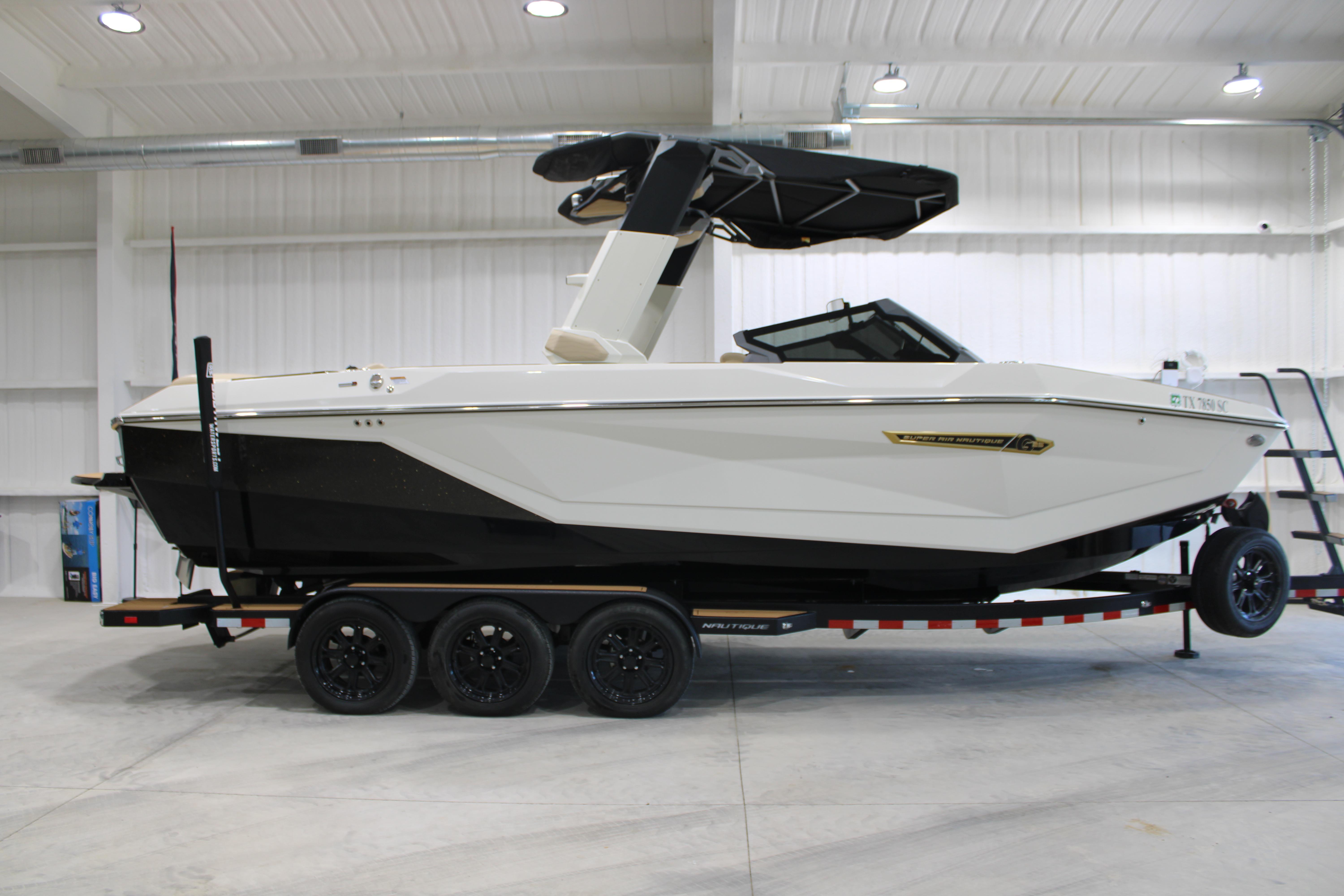 2025 Nautique Super Air Nautique G25 boat on trailer in indoor storage.