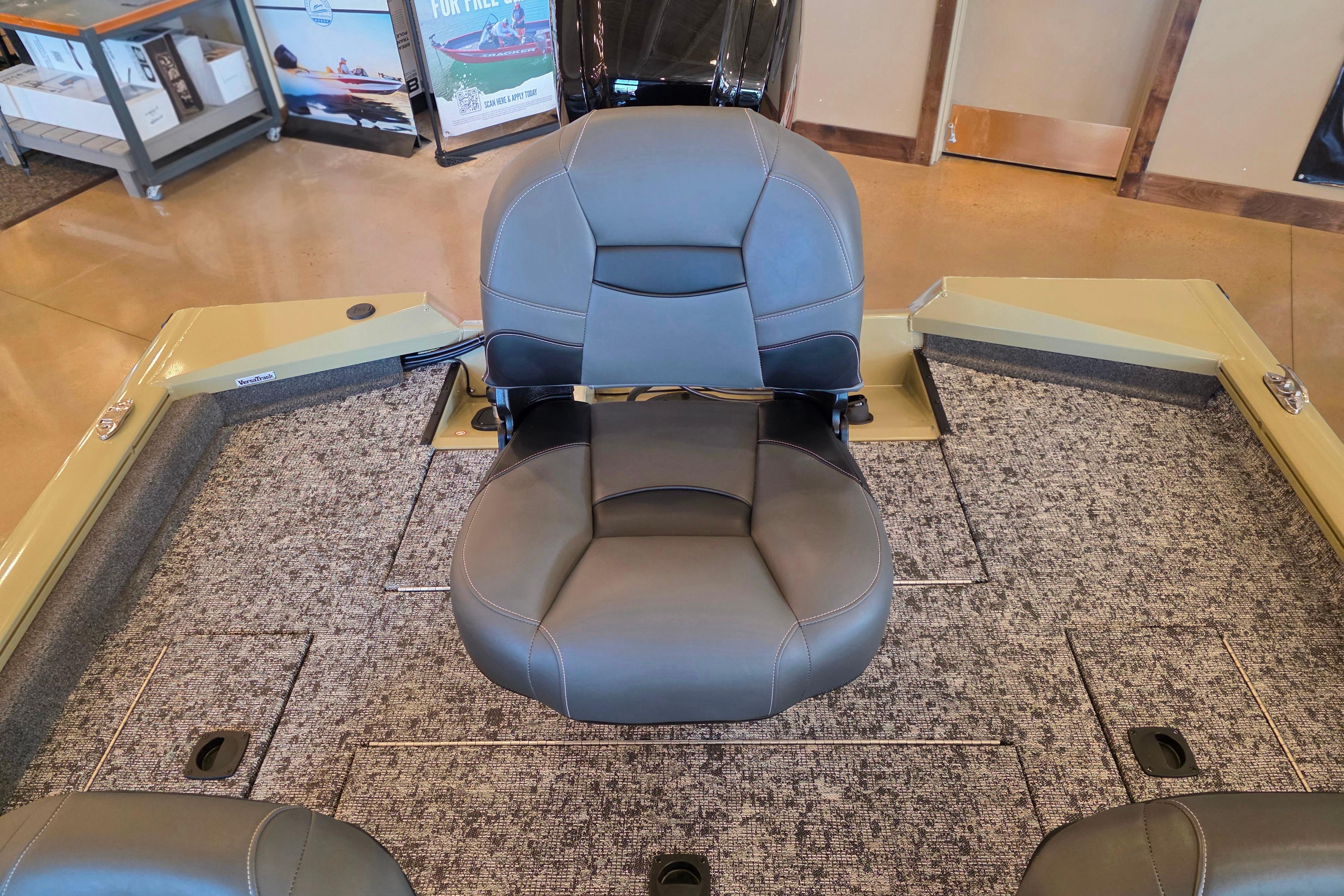 2026 Tracker Pro Team 175 Crappie Edition boat interior with gray seating and carpeted flooring.