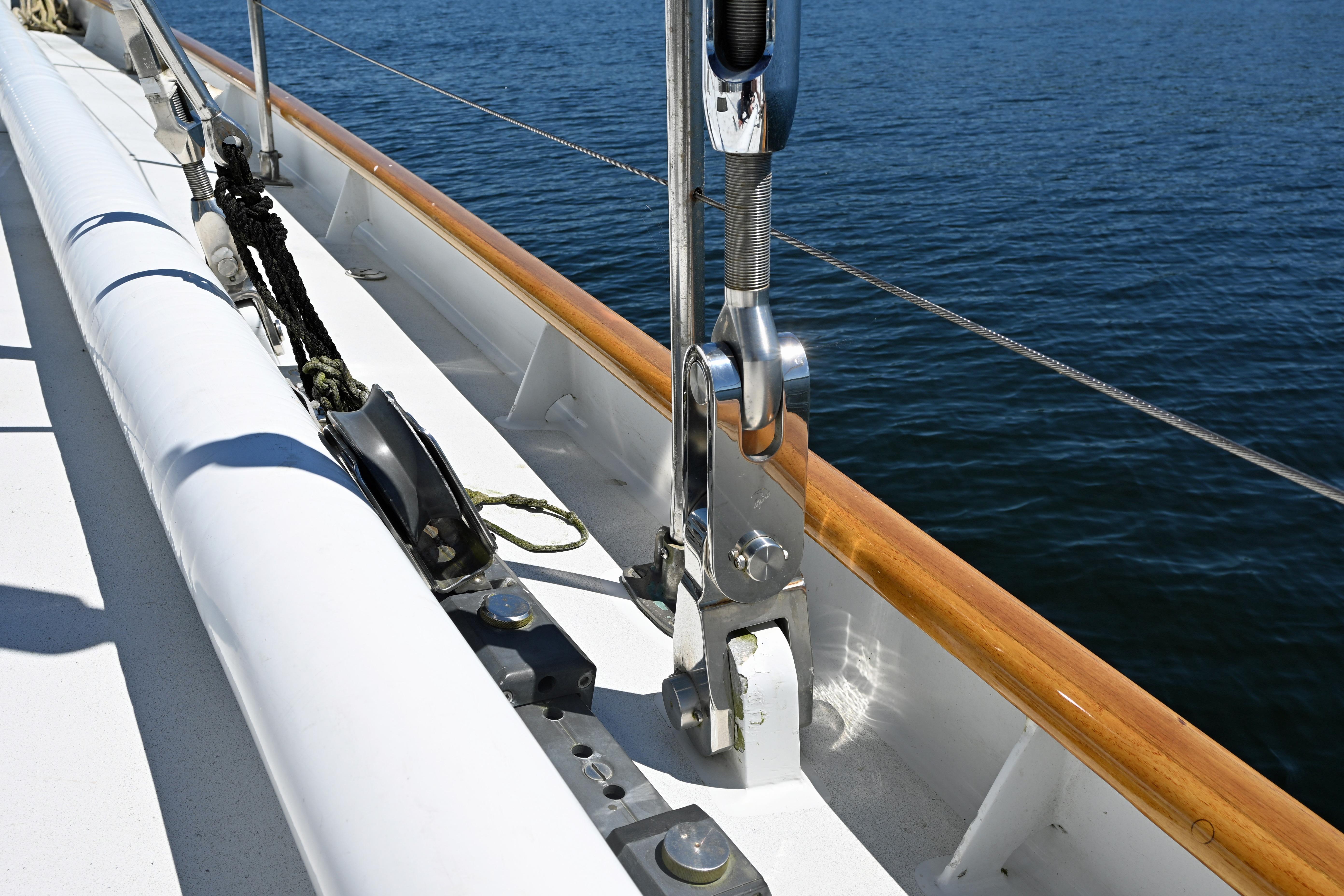 Deck view of 1968 Abeking & Rasmussen Tripp 74 yacht, showcasing rigging and polished woodwork.