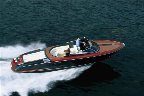 2005 Riva Aquariva speedboat cruising on open water, showcasing sleek design and luxury.