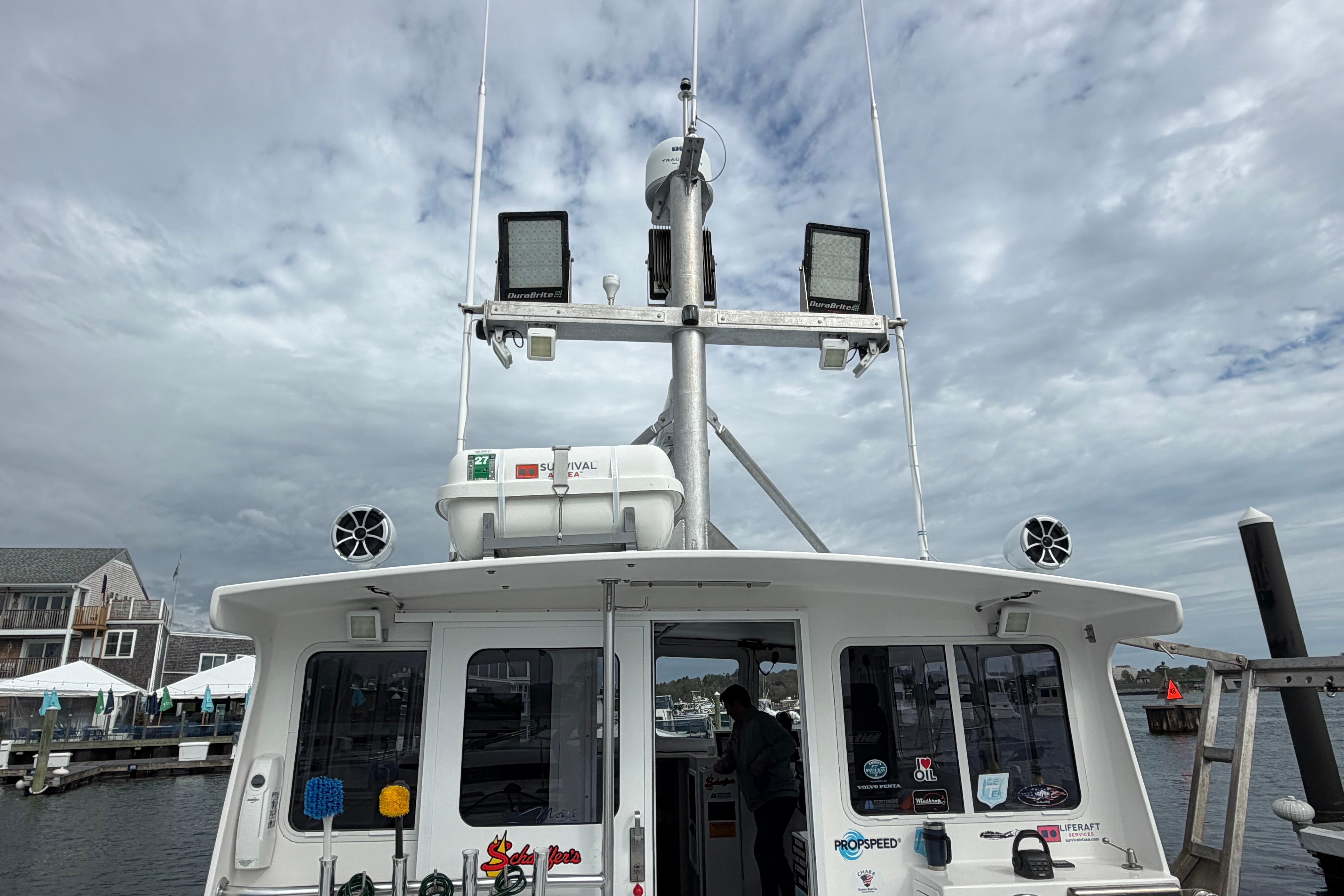 2018 H&H Marine Osmond Beal boat docked under cloudy skies.