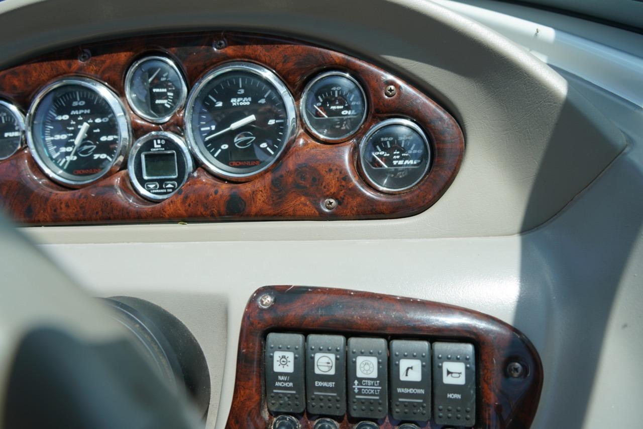 Dashboard of a 2004 Crownline 216 LS boat with gauges and control switches.