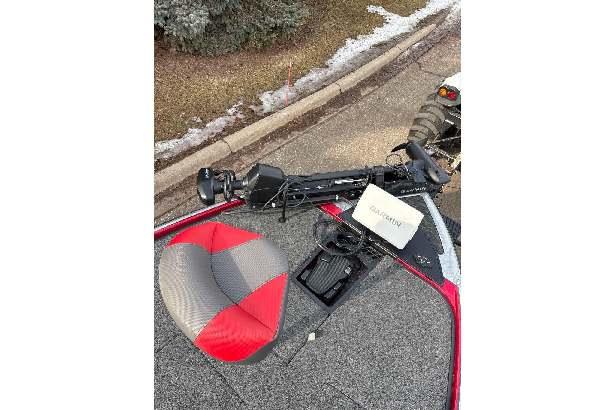 2026 Nitro Z20 XL Pro boat with Garmin equipment and red-gray seat on a paved road.