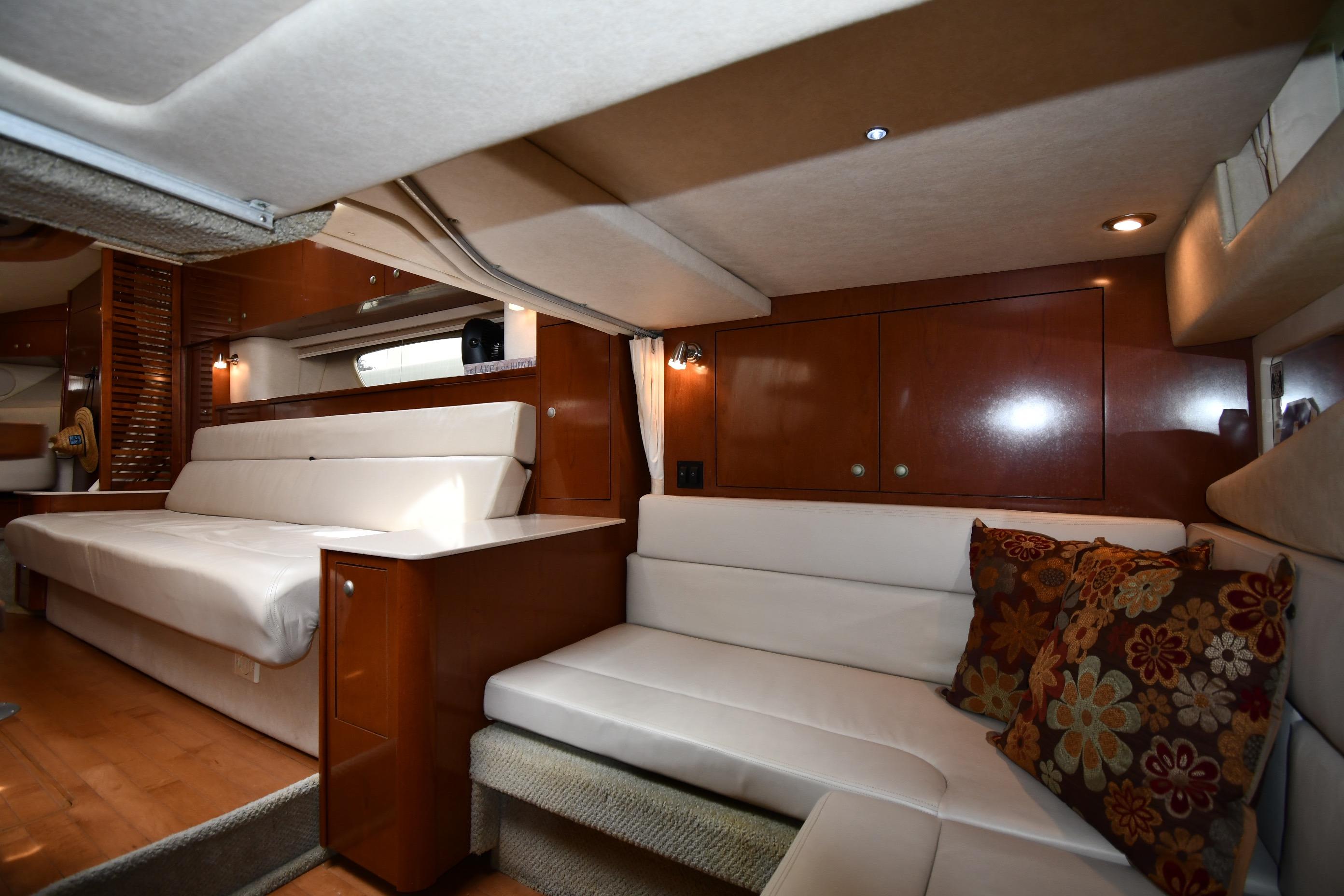 Luxurious interior of 2008 Sea Ray Sundancer 350 yacht with plush seating and elegant wood finishes.