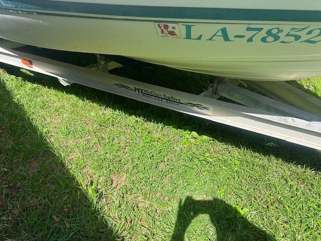 Skeeter ZX2200 boat on McClain trailer, grass background.